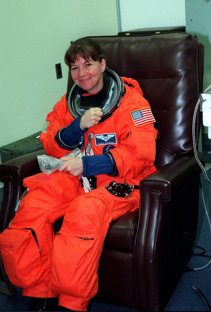 For the third time, during final launch preparations in the Operations and Checkout Building, STS-93 Mission Specialist Catherine G. Coleman (Ph.D.) dons her launch and entry suit. After Space Shuttle Columbia's July 20 and 22 launch attempts were scrubbed, the launch was again rescheduled for Friday, July 23, at 12:24 a.m. EDT. STS-93 is a five-day mission primarily to release the Chandra X-ray Observatory, which will allow scientists from around the world to study some of the most distant, powerful and dynamic objects in the universe. The STS-93 crew numbers five: Commander Eileen M. Collins, Pilot Jeffrey S. Ashby, and Mission Specialists Steven A. Hawley (Ph.D.), Coleman, and Michel Tognini of France, with the Centre National d'Etudes Spatiales (CNES). Collins is the first woman to serve as commander of a shuttle mission
