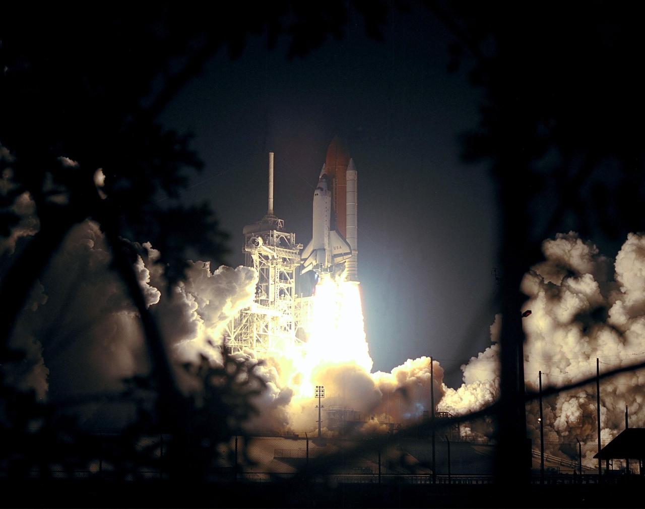 KENNEDY SPACE CENTER, FLA. -- The fiery launch of Space Shuttle Columbia casts ghost-like shadows on the clouds of smoke and steam surrounding it. Liftoff occurred at 12:31 a.m. EDT. STS-93 is a five-day mission primarily to release the Chandra X-ray Observatory, which will allow scientists from around the world to study some of the most distant, powerful and dynamic objects in the universe. The crew numbers five: Commander Eileen M. Collins, Pilot Jeffrey S. Ashby, and Mission Specialists Steven A. Hawley (Ph.D.), Catherine G. Coleman (Ph.D.) and Michel Tognini of France, with the Centre National d'Etudes Spatiales (CNES). Collins is the first woman to serve as commander of a Shuttle mission. The target landing date is July 27, 1999, at 11:20 p.m. EDT