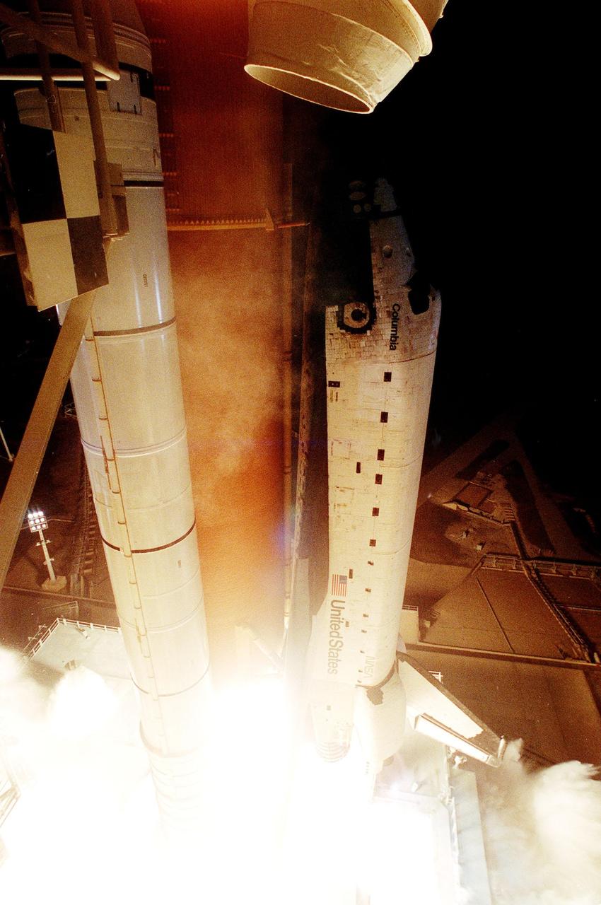 KENNEDY SPACE CENTER, FLA. -- In a burst of light and flames, Space Shuttle Columbia lifts off from Launch Pad 39-B at 12:31 a.m. EDT. STS-93 is a five-day mission primarily to release the Chandra X-ray Observatory, which will allow scientists from around the world to study some of the most distant, powerful and dynamic objects in the universe. The crew numbers five: Commander Eileen M. Collins, Pilot Jeffrey S. Ashby, and Mission Specialists Steven A. Hawley (Ph.D.), Catherine G. Coleman (Ph.D.) and Michel Tognini of France, with the Centre National d'Etudes Spatiales (CNES). Collins is the first woman to serve as commander of a Shuttle mission. The target landing date is July 27, 1999, at 11:20 p.m. EDT