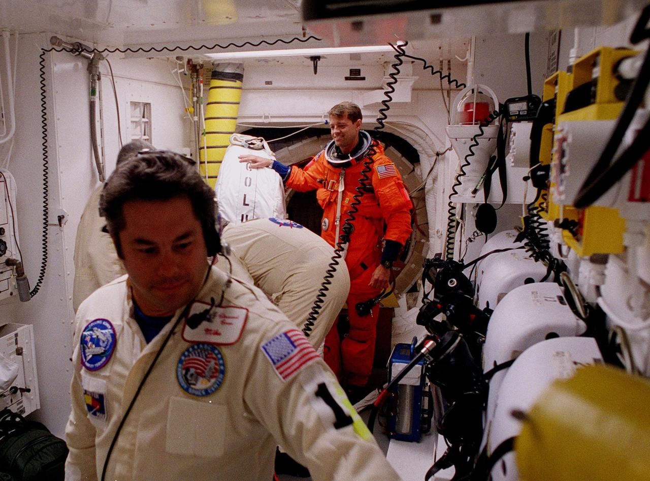STS-93 Pilot Jeffrey S. Ashby is checked out by white room closeout crew members before entering the orbiter Columbia. The white room is an environmental chamber at the end of the orbiter access arm that provides entry to the orbiter crew compartment. STS-93 is a five-day mission primarily to release the Chandra X-ray Observatory, which will allow scientists from around the world to study some of the most distant, powerful and dynamic objects in the universe. After Space Shuttle Columbia's July 20 and 22 launch attempts were scrubbed, the launch was again rescheduled for Friday, July 23, at 12:24 a.m. EDT. The target landing date is July 27 at 11:20 p.m. EDT