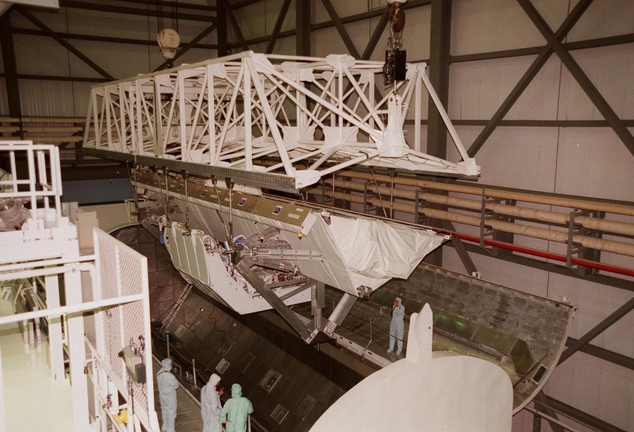 KENNEDY SPACE CENTER, FLA. -- A crane lifts the Shuttle Radar Topography Mission (SRTM), the primary payload on STS-99, from a payload canister used to transport it to Orbiter Processing Facility (OPF) bay 2. The SRTM will soon be installed into the payload bay of the orbiter Endeavour. The SRTM consists of a specially modified radar system that will gather data for the most accurate and complete topographic map of the Earth's surface that has ever been assembled. SRTM will make use of radar interferometry, wherein two radar images are taken from slightly different locations. Differences between these images allow for the calculation of surface elevation. The SRTM hardware includes one radar antenna in the Shuttle payload bay and a second radar antenna attached to the end of a mast extended 60 meters (195 feet) from the shuttle. STS-99 is scheduled to launch Sept. 16 at 8:47 a.m. from Launch Pad 39A