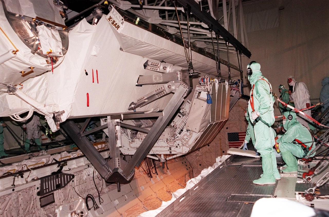 KENNEDY SPACE CENTER, FLA. -- A crane lowers the Shuttle Radar Topography Mission (SRTM), the primary payload on STS-99, into the payload bay of the orbiter Endeavour in Orbiter Processing Facility bay 2. The SRTM consists of a specially modified radar system that will gather data for the most accurate and complete topographic map of the Earth's surface that has ever been assembled. SRTM will make use of radar interferometry, wherein two radar images are taken from slightly different locations. Differences between these images allow for the calculation of surface elevation. The SRTM hardware includes one radar antenna in the Shuttle payload bay and a second radar antenna attached to the end of a mast extended 60 meters (195 feet) from the shuttle. STS-99 is scheduled to launch Sept. 16 at 8:47 a.m. from Launch Pad 39A