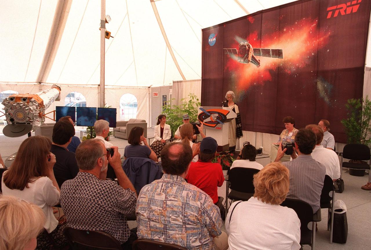 Mrs. Lalitha Chandrasekhar (at podium), wife of the late Indian-American Nobel Laureate Subrahmanyan Chandrasekhar, addresses the media and other invited guests in the TRW Media Hospitality Tent at the NASA Press Site at KSC. Other participants in the program (seated facing the audience, left to right) are the winners of the contest to rename the telescope, Jatila van der Veen, academic coordinator and lecturer, Physics Dept., University of Santa Barbara, Calif., and Tyrel Johnson, high school student, Laclede, Idaho; Joanne Maguire, vice-president and general manager, TRW Space & Laser Programs Division; and Dr. Alan Bunner, Science Program Director, Structure and Evolution of the Universe, Office of Space Science, NASA Headquarters, Washington, D.C. The name "Chandra," a shortened version of Chandrasekhar, was the name the Nobel Laureate preferred among friends and colleagues. "Chandra" also means "Moon" or "luminous" in Sanskrit. The observatory is scheduled to be launched aboard Columbia on Space Shuttle mission STS-93
