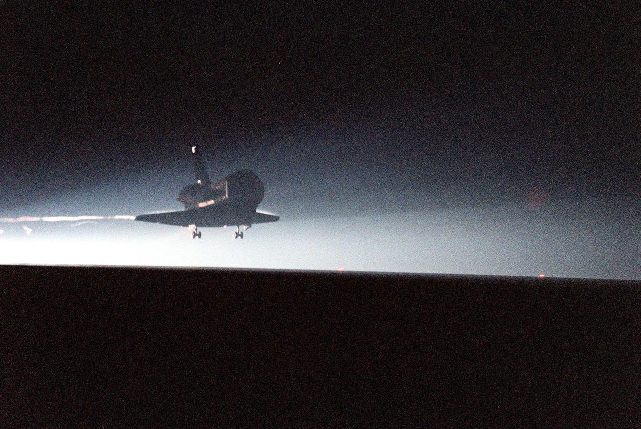 KENNEDY SPACE CENTER, Fla. -- The Space Shuttle orbiter Columbia swoops out of the darkness onto runway 33 at the Shuttle Landing Facility after a successful mission of nearly five days and 1.8 million miles. Main gear touchdown was at 11:20:35 p.m. EDT on July 27. Aboard are the STS-93 crew members: Commander Eileen M. Collins, Pilot Jeffrey S. Ashby, and Mission Specialists Steven A. Hawley (Ph.D.), Catherine G. Coleman (Ph.D.) and Michel Tognini of France, with the Centre National d'Etudes Spatiales (CNES). The mission's primary objective was to deploy the Chandra X-ray Observatory, which will allow scientists from around the world to study some of the most distant, powerful and dynamic objects in the universe. This was the 95th flight in the Space Shuttle program and the 26th for Columbia. The landing was the 19th consecutive Shuttle landing in Florida and the 12th night landing in Shuttle program history