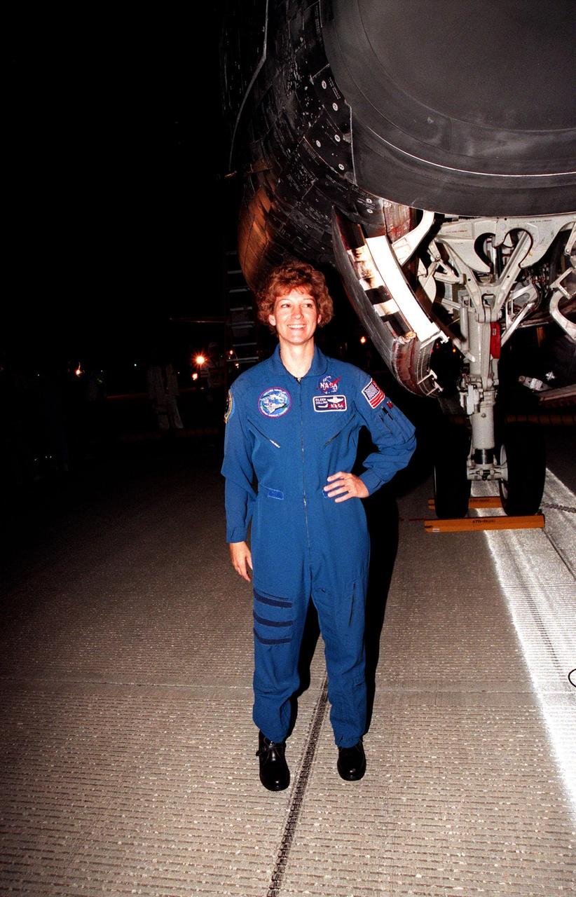 KENNEDY SPACE CENTER, FLA. -- STS-93 Commander Eileen Collins poses in front of the Space Shuttle orbiter Columbia following her textbook landing on runway 33 at the Shuttle Landing Facility. Main gear touchdown occurred at 11:20:35 p.m. EDT on July 27. On this mission, Collins became the first woman to serve as a Shuttle commander. Also on board were her fellow STS-93 crew members: Pilot Jeffrey S. Ashby and Mission Specialists Steven A. Hawley (Ph.D.), Catherine G. Coleman (Ph.D.) and Michel Tognini of France, with the Centre National d'Etudes Spatiales (CNES). The mission's primary objective was to deploy the Chandra X-ray Observatory, which will allow scientists from around the world to study some of the most distant, powerful and dynamic objects in the universe. This was the 95th flight in the Space Shuttle program and the 26th for Columbia. The landing was the 19th consecutive Shuttle landing in Florida and the 12th night landing in Shuttle program history