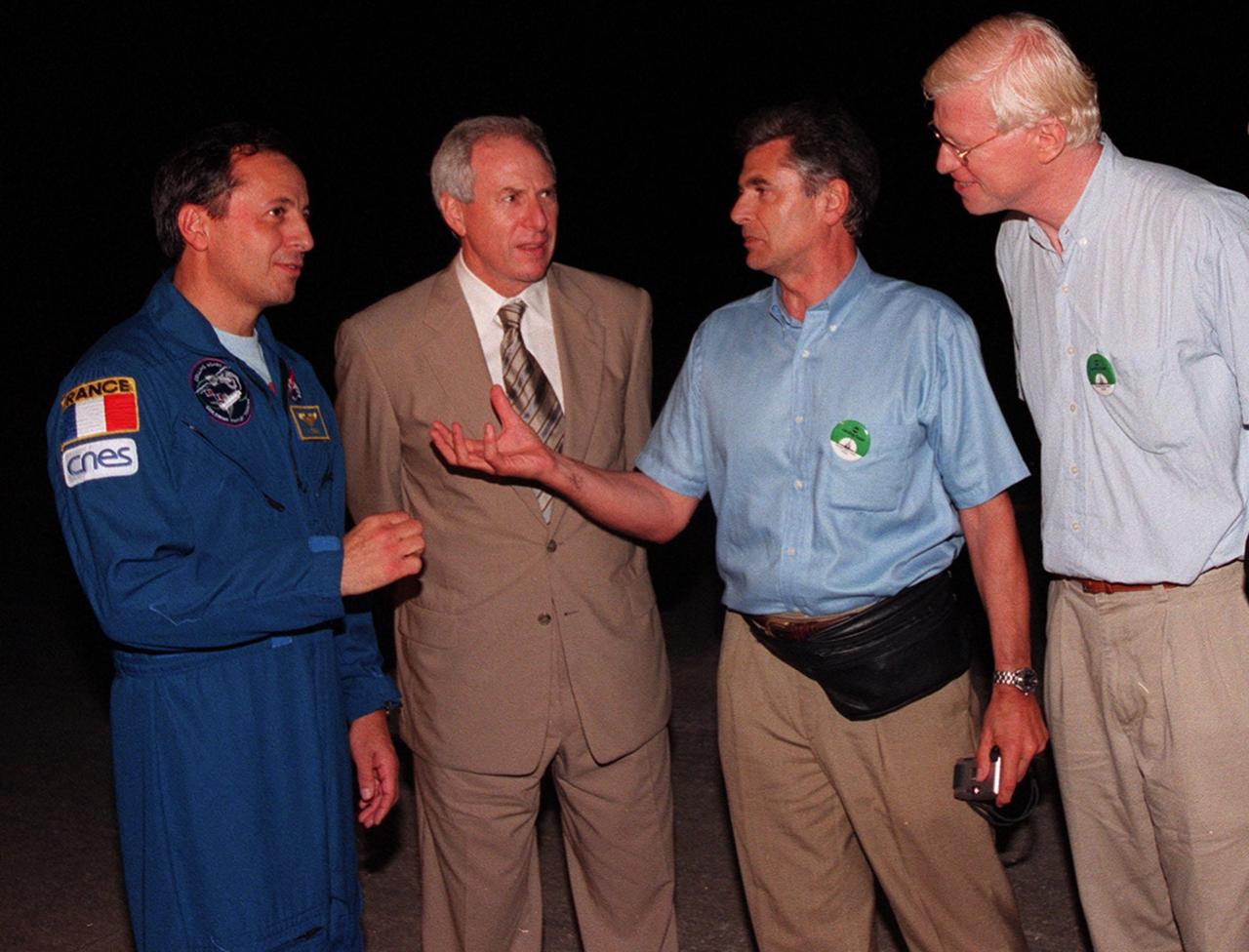 At the Shuttle Landing Facility (from left to right), STS-93 Mission Specialist Michel Tognini of France, representing the Centre National d'Etudes Spatiales (CNES), and NASA Administrator Daniel Goldin talk with Jacques Ratie, Astronaut Director, CNES, and Serge Plattard, International Relations, CNES. Landing occurred on runway 33 with main gear touchdown at 11:20:35 p.m. EDT on July 27. The mission's primary objective was to deploy the Chandra X-ray Observatory, which will allow scientists from around the world to study some of the most distant, powerful and dynamic objects in the universe. This was the 95th flight in the Space Shuttle program and the 26th for Columbia. The landing was the 19th consecutive Shuttle landing in Florida and the 12th night landing in Shuttle program history. On this mission, Eileen Collins became the first woman to serve as a Shuttle commander