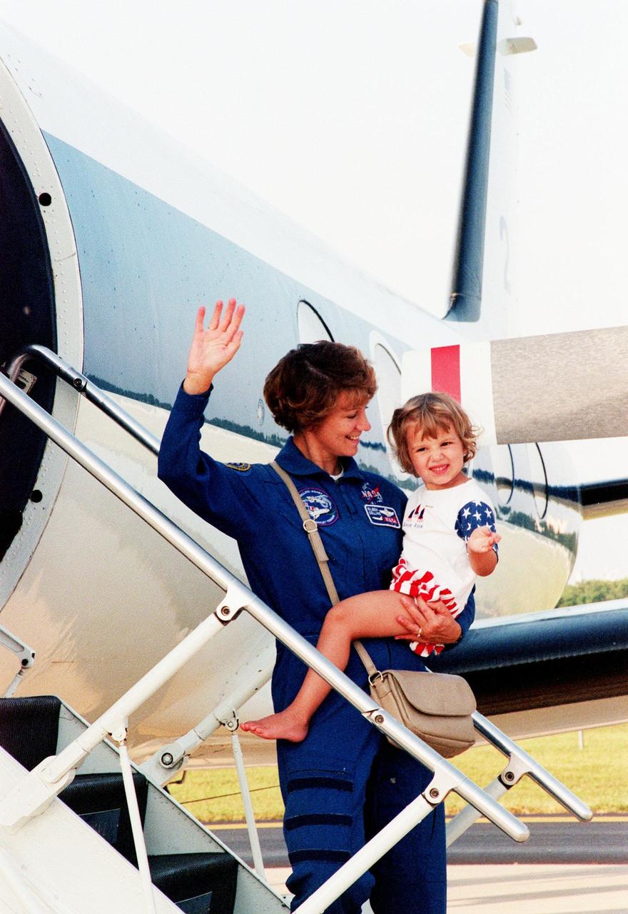 At the Skid Strip at the Cape Canaveral Air Station, Commander Eileen Collins and her daughter Bridget Youngs prepare to board an aircraft for their return flight to Houston following the completion of the STS-93 Space Shuttle mission. Landing occurred on runway 33 at KSC's Shuttle Landing Facility with main gear touchdown at 11:20:35 p.m. EDT on July 27. The mission's primary objective was to deploy the Chandra X-ray Observatory, which will allow scientists from around the world to study some of the most distant, powerful and dynamic objects in the universe. This was the 95th flight in the Space Shuttle program and the 26th for Columbia. The landing was the 19th consecutive Shuttle landing in Florida and the 12th night landing in Shuttle program history. On this mission, Collins became the first woman to serve as a Shuttle commander