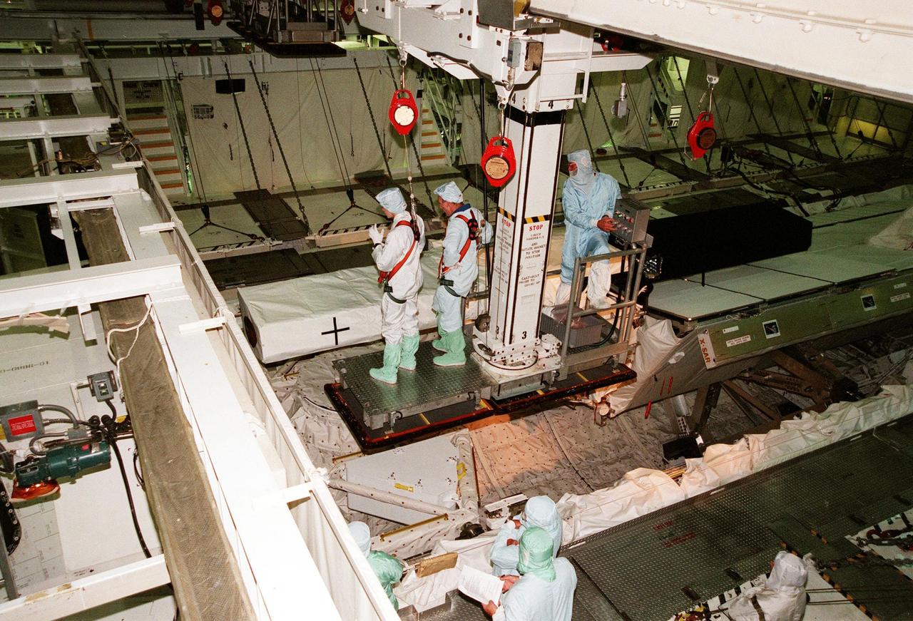 KENNEDY SPACE CENTER, FLA. -- In the Orbiter Processing Facility, members of the STS-99 crew look over the Shuttle Radar Topography Mission (SRTM), primary payload for their mission, as part of a Crew Equipment Interface Test (CEIT). Participating are Commander Kevin R. Kregel, Pilot Dominic L. Pudwill Gorie, and Mission Specialists Janet Lynn Kavandi (Ph.D.), Janice Voss (Ph.D), Mamoru Mohri, and Gerhard P.J. Thiele. Mohri is with the National Space Development Agency (NASDA) of Japan, and Thiele is with the European Space Agency. The CEIT provides an opportunity for crew members to check equipment and facilities that will be aboard the orbiter during their mission. The SRTM is a specially modified radar system that will gather data for the most accurate and complete topographic map of the Earth's surface that has ever been assembled. SRTM will make use of radar interferometry, wherein two radar images are taken from slightly different locations. Differences between these images allow for the calculation of surface elevation, or change. The SRTM hardware will consist of one radar antenna in the shuttle payload bay and a second radar antenna attached to the end of a mast extended 60 meters (195 feet) out from the shuttle. STS-99 is scheduled to launch Sept. 16 at 8:47 a.m. from Launch Pad 39A