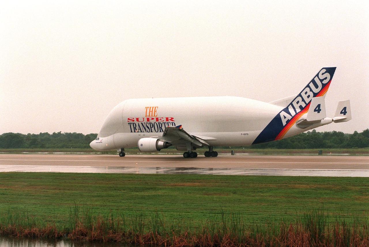 KENNEDY SPACE CENTER, FLA. -- An Airbus Industrie A300-600ST "Beluga" Super Transporter lands in the rain at the Shuttle Landing Facility to deliver its cargo, the second Multi-Purpose Logistics Module (MPLM) for the International Space Station (ISS). One of Italy's major contributions to the ISS program, the MPLM, named Raffaello, is a reusable logistics carrier and the primary delivery system used to resupply and return station cargo requiring a pressurized environment. Weighing nearly 4.5 tons, the module measures 21 feet long and 15 feet in diameter. Raffaello will join Leonardo, the first Italian-built MPLM, in the Space Station Processing Facility for testing. NASA, Boeing, the Italian Space Agency and Alenia Aerospazio will provide engineering support
