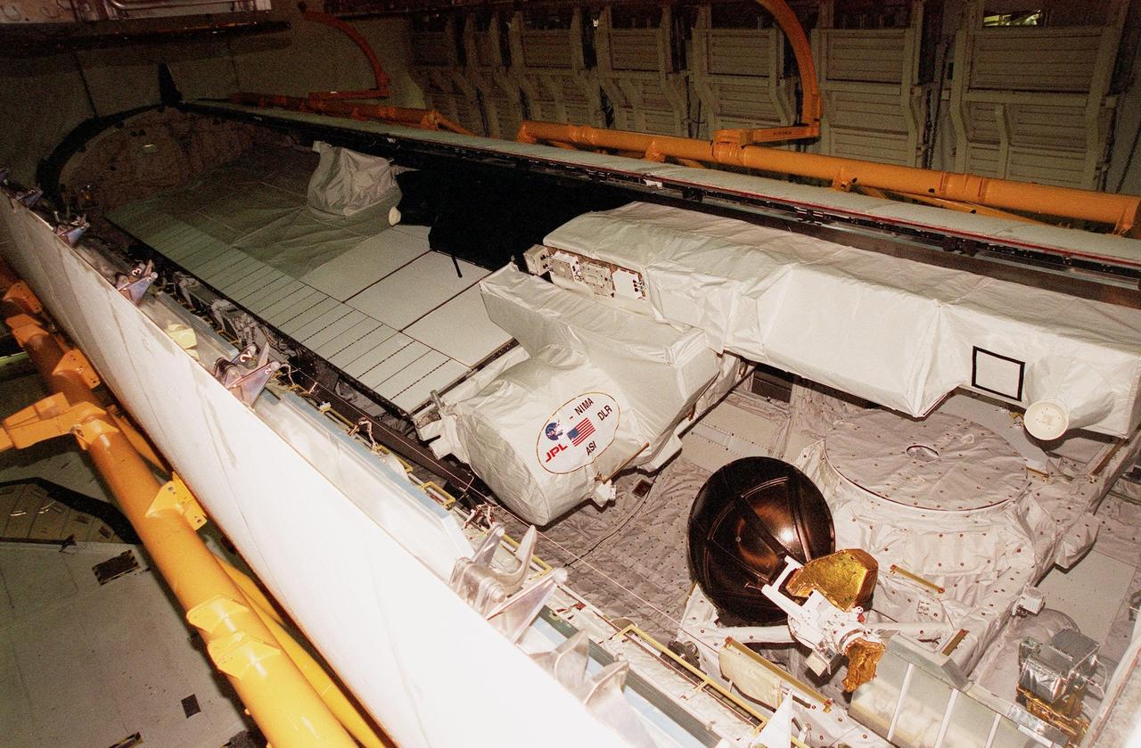 KENNEDY SPACE CENTER, FLA. -- In the Orbiter Processing Facility, a radar antenna, part of the Shuttle Radar Topography Mission (SRTM), is stored in the payload bay of the orbiter Endeavour before door closure. SRTM is the primary payload on mission STS-99, scheduled to launch Sept. 16 at 8:47 a.m. EDT from Launch Pad 39A. A specially modified radar system, the SRTM will gather data for the most accurate and complete topographic map of the Earth's surface that has ever been assembled. SRTM will make use of radar interferometry, wherein two radar images are taken from slightly different locations. Differences between these images allow for the calculation of surface elevation, or change. The SRTM hardware consists of one radar antenna in the shuttle payload bay and a second radar antenna attached to the end of a mast extended 60 meters (195 feet) out from the shuttle. SRTM is an international project spearheaded by the National Imagery and Mapping Agency and NASA, with participation of the German Aerospace Center DLR