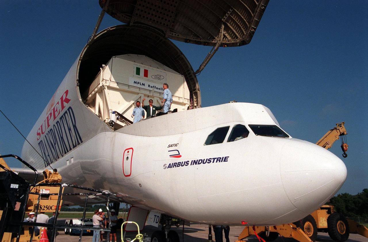 KENNEDY SPACE CENTER, FLA. -- At the Shuttle Landing Facility, workers begin offloading the Raffaello, the second Multi-Purpose Logistics Module (MPLM) for the International Space Station (ISS), from the "Beluga" Super Transporter that brought it from Italy. One of Italy's major contributions to the ISS program, the MPLM is a reusable logistics carrier and the primary delivery system used to resupply and return station cargo requiring a pressurized environment. Weighing nearly 4.5 tons, the module measures 21 feet long and 15 feet in diameter. Raffaello will join Leonardo, the first Italian-built MPLM, in the Space Station Processing Facility for testing. NASA, Boeing, the Italian Space Agency and Alenia Aerospazio will provide engineering support