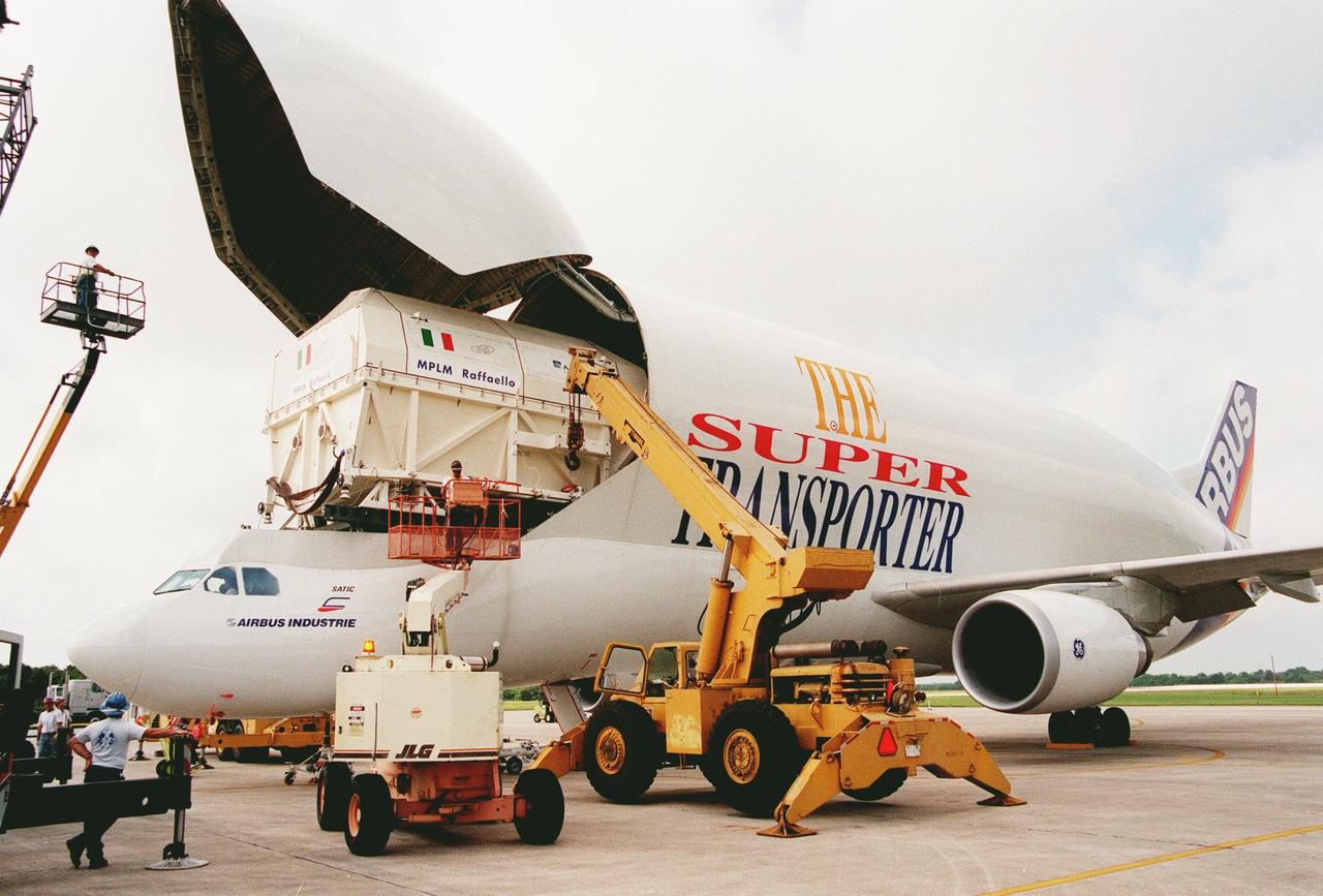 KENNEDY SPACE CENTER, FLA. -- A crane is attached to the Raffaello, the second Multi-Purpose Logistics Module (MPLM) for the International Space Station (ISS), before offloading the MPLM from the "Beluga" Super Transporter. One of Italy's major contributions to the ISS program, the MPLM is a reusable logistics carrier and the primary delivery system used to resupply and return station cargo requiring a pressurized environment. Weighing nearly 4.5 tons, the module measures 21 feet long and 15 feet in diameter. Raffaello will join Leonardo, the first Italian-built MPLM, in the Space Station Processing Facility for testing. NASA, Boeing, the Italian Space Agency and Alenia Aerospazio will provide engineering support
