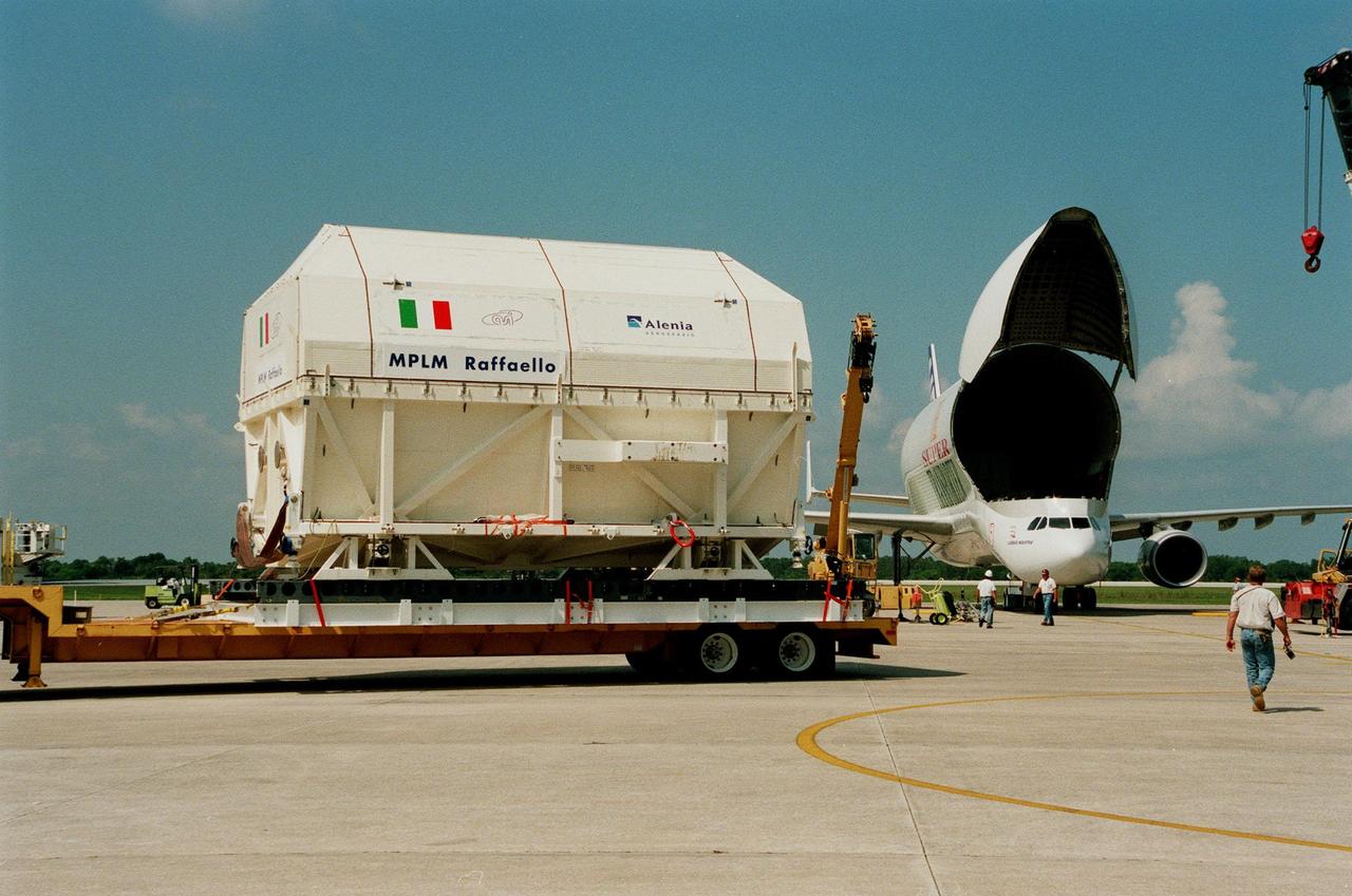 KENNEDY SPACE CENTER, FLA. -- The Multi-Purpose Logistics Module (MPLM) called Raffaello sits on a transporter waiting for transfer to the Space Station Processing Facility (SSPF). At the SSPF the Raffaello will undergo testing, joining the first Italian-built MPLM, Leonardo. One of Italy's major contributions to the ISS program, the MPLM is a reusable logistics carrier and the primary delivery system used to resupply and return station cargo requiring a pressurized environment. Weighing nearly 4.5 tons, the Raffaello measures 21 feet long and 15 feet in diameter. Raffaello is scheduled to be launched on mission STS-100 July 27, 2000