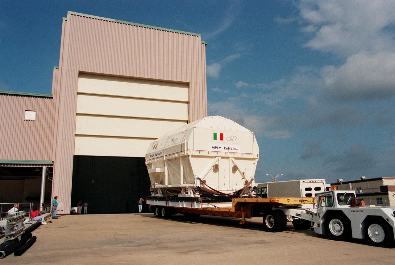 KENNEDY SPACE CENTER, FLA. -- The Multi-Purpose Logistics Module (MPLM) called Raffaello arrives in its shipping canister at the Space Station Processing Facility (SSPF). There it will undergo testing, joining the first Italian-built MPLM, Leonardo, in the SSPF. One of Italy's major contributions to the ISS program, the MPLM is a reusable logistics carrier and the primary delivery system used to resupply and return station cargo requiring a pressurized environment. Weighing nearly 4.5 tons, the Raffaello measures 21 feet long and 15 feet in diameter. Raffaello is scheduled to be launched on mission STS-100 July 27, 2000