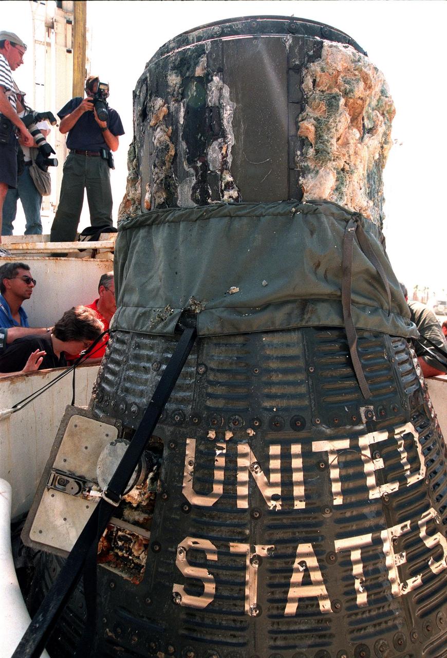 KENNEDY SPACE CENTER, FLA. -- A close-up of the recently recovered Liberty Bell 7 Project Mercury capsule from the ocean floor shows the lettering "United States" still clearly visible on its side. Thirty-eight years ago, the capsule made a successful 16-minute suborbital flight, with astronaut Virgil "Gus" Grissom aboard, and splashed down in the Atlantic Ocean.  A prematurely jettisoned hatch caused the capsule to flood and a Marine rescue helicopter was unable to lift it.  It quickly sank to a three-mile depth.  Grissom was rescued but his spacecraft remained lost on the ocean floor, until now. In an expedition sponsored by the Discovery Channel, underwater salvage expert Curt Newport fulfilled a 14-year dream in finding and, after one abortive attempt, successfully raising the capsule and bringing it to Port Canaveral. The capsule is being moved to the Kansas Cosmosphere and Space Center in Hutchinson, Kansas,  where it will be restored for eventual public display. Newport has also been involved in salvage operations of the Space Shuttle Challenger and TWA Flight 800 that crashed off the coast of Long Island, N.Y.