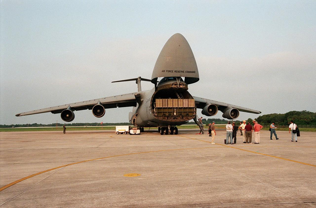 A C-5 air cargo plane opens to reveal a shipping container with payload flight hardware for the Third Hubble Space Telescope Servicing Mission (SM-3A). The hardware will be taken to the Payload Hazardous Servicing Facility for final testing and integration of payload elements. Mission STS-103 is a "call-up" mission which is being planned due to the need to replace portions of the Hubble's pointing system, the gyros, which have begun to fail. Although Hubble is operating normally and conducting its scientific observations, only three of its six gyroscopes are working properly. The gyroscopes allow the telescope to point at stars, galaxies and planets. The STS-103 crew will not only replace gyroscopes, it will also replace a Fine Guidance Sensor and an older computer with a new enhanced model, an older data tape recorder with a solid state digital recorder, a failed spare transmitter with a new one, and degraded insulation on the telescope with new thermal insulation. The crew will also install a Battery Voltage/Temperature Improvement Kit to protect the spacecraft batteries from overcharging and overheating when the telescope goes into a safe mode. Launch of STS-93 is currently targeted for Oct. 14 but under review, pending the launch date of a prior mission, STS-99, also under review