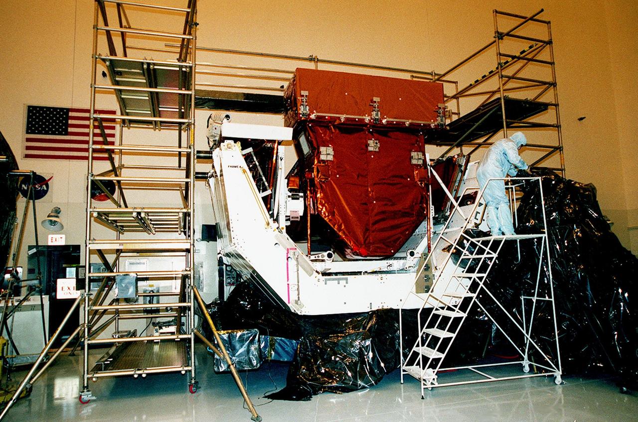 KENNEDY SPACE CENTER, FLA. -- Inside the Payload Hazardous Servicing Facility (PHSF), a part of payload flight hardware, intended for the third Hubble Space Telescope Servicing Mission (SM-3A), is revealed after its protective cover has been removed. The hardware will undergo final testing and integration of payload elements in the PHSF. Mission STS-103 is a "call-up" mission which is being planned due to the need to replace portions of the Hubble's pointing system, the gyros, which have begun to fail. Although Hubble is operating normally and conducting its scientific observations, only three of its six gyroscopes are working properly. The gyroscopes allow the telescope to point at stars, galaxies and planets. The STS-103 crew will not only replace gyroscopes, it will also replace a Fine Guidance Sensor and an older computer with a new enhanced model, an older data tape recorder with a solid state digital recorder, a failed spare transmitter with a new one, and degraded insulation on the telescope with new thermal insulation. The crew will also install a Battery Voltage/Temperature Improvement Kit to protect the spacecraft batteries from overcharging and overheating when the telescope goes into a safe mode. Launch of STS-103 is currently targeted for Oct. 14 but the date is under review