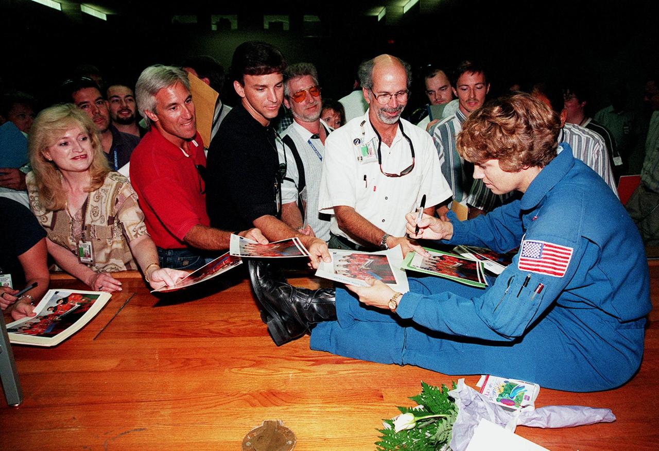 STS-93 Commander Eileen M. Collins signs autographs after a mission presentation for KSC employees. The five-day mission primarily released the Chandra X-ray Observatory, allowing scientists from around the world to study some of the most distant, powerful and dynamic objects in the universe. Chandra is expected to provide unique and crucial information on the nature of objects ranging from comets in our solar system to quasars at the edge of the observable universe. Since X-rays are absorbed by the Earth's atmosphere, space-based observatories are necessary to study these phenomena and allow scientists to analyze some of the greatest mysteries of the universe. STS-93 was also the first mission to have a woman serving as Shuttle commander