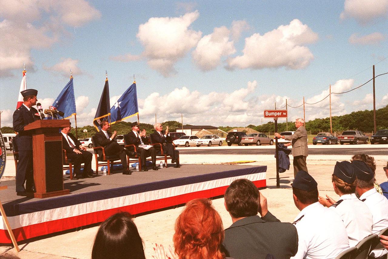 At Cape Canaveral Air Station's (CCAS) Complex 3/4, officials held a ceremony kicking off a year-long series of events commemorating 50 years of launches from the Space Coast that began with the Bumper rockets. At right, Norris Gray, a Bumper Program veteran, unveils a street sign that will be used to mark the road leading to the launch complex from which Bumper was launched. Seen on the stage are, left to right, Lt. Col. Randall K. Horn (at the podium), Commander, CCAS; Congressman David Weldon, 15th Congressional District of the State of Florida; Lieutenant Governor of the State of Florida Frank T. Brogan; Center Director Roy D. Bridges; and Executive Director Edward F. Gormel, Joint Performance Management Office. Also present (but not seen) is Brig. Gen. Donald P. Pettit, Commander, 45th Space Wing. After six Bumper launches at White Sands Proving Grounds, N.M., and a failed Bumper 7, a successful Bumper 8 lifted off July 24, 1950, from Complex 3/4 to conduct aerodynamic investigations around Mach 7 at relatively low altitudes. The kick-off event also inaugurated a student art contest to design a commemorative etching. The winning artwork will be permanently displayed on a 24-inch black granite square in the U.S. Space Walk Hall of Fame in Titusville, Fla