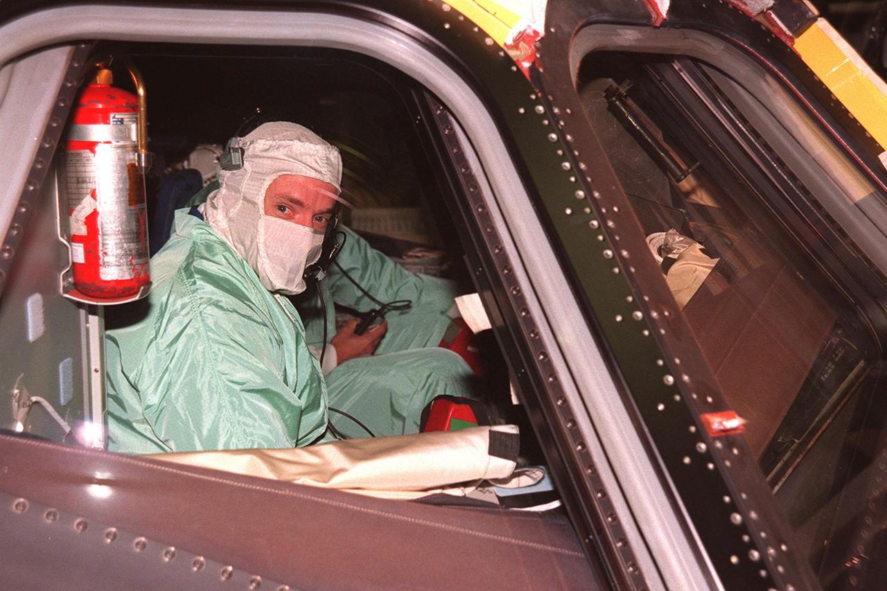 In the Orbiter Processing Facility (OPF) bay 1, STS-103 Pilot Scott J. Kelly sits in the pilot's seat of the orbiter Discovery, inspecting the window. The mission will be Kelly's first Space Shuttle flight. Kelly and other crew members are at KSC to take part in a Crew Equipment Interface Test. The rest of the crew are Commander Curtis L. Brown Jr. and Mission Specialists Steven L. Smith, C. Michael Foale (Ph.D.), John M. Grunsfeld (Ph.D.), Claude Nicollier of Switzerland, and Jean-François Clervoy of France. Nicollier and Clervoy are with the European Space Agency. Mission STS-103 is a "call-up" due to the need to replace portions of the pointing system, the gyros, which have begun to fail on the Hubble Space Telescope. Although Hubble is operating normally and conducting its scientific observations, only three of its six gyroscopes are working properly. The gyroscopes allow the telescope to point at stars, galaxies and planets. The STS-103 crew will not only replace gyroscopes, it will also replace a Fine Guidance Sensor and an older computer with a new enhanced model, an older data tape recorder with a solid-state digital recorder, a failed spare transmitter with a new one, and degraded insulation on the telescope with new thermal insulation. The crew will also install a Battery Voltage/Temperature Improvement Kit to protect the spacecraft batteries from overcharging and overheating when the telescope goes into a safe mode. The scheduled launch date in October is under review
