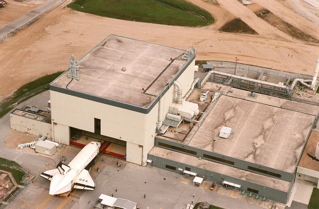 KENNEDY SPACE CENTER, FLA. -- The orbiter Columbia rolls out of KSC's Orbiter Processing Facility bay 3, bound for the Shuttle Landing Facility's (SLF) Mate-Demate Device. At the SLF the orbiter is to be mated to the Boeing 747 Shuttle Carrier Aircraft for a ferry flight to Palmdale, Calif. On the rear of the orbiter can be seen the tail cone, a fairing that is installed over the aft fuselage of the orbiter to decrease aerodynamic drag and buffet when the Shuttle Carrier Aircraft is transporting the orbiter cross-country. It is 36 feet long, 25 feet wide, and 22 feet high. Columbia, the oldest of four orbiters in NASA's fleet, will undergo extensive inspections and modifications in Boeing's Orbiter Assembly Facility during a nine-month orbiter maintenance down period (OMDP), the second in its history. Orbiters are periodically removed from flight operations for an OMDP. Columbia's first was in 1994. Along with more than 100 modifications on the vehicle, Columbia will be the second orbiter to be outfitted with the multifunctional electronic display system, or "glass cockpit." Columbia is expected to return to KSC in July 2000