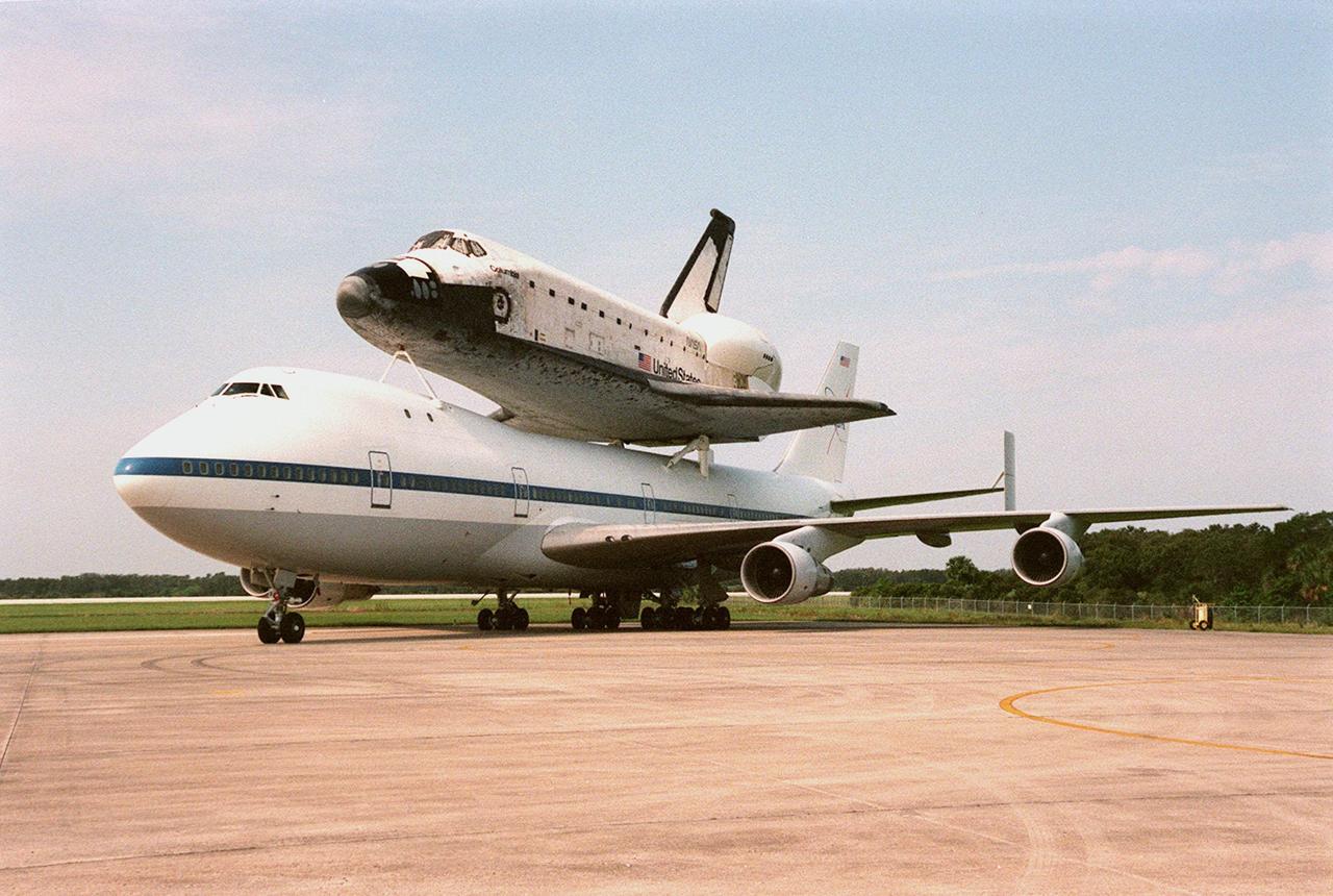 KENNEDY SPACE CENTER, FLA. -- The Boeing 747 Shuttle Carrier Aircraft, with the orbiter Columbia strapped to its back, waits at the Shuttle Landing Facility for clear weather to take off for its final destination, Palmdale, Calif. The oldest of four orbiters in NASA's fleet, Columbia is being ferried to Palmdale to undergo extensive inspections and modifications in Boeing's Orbiter Assembly Facility. The nine-month orbiter maintenance down period (OMDP) is the second in Columbia's history. Orbiters are periodically removed from flight operations for an OMDP. Columbia's first was in 1994. Along with more than 100 modifications on the vehicle, Columbia will be the second orbiter to be outfitted with the multifunctional electronic display system, or "glass cockpit." Columbia is expected to return to KSC in July 2000
