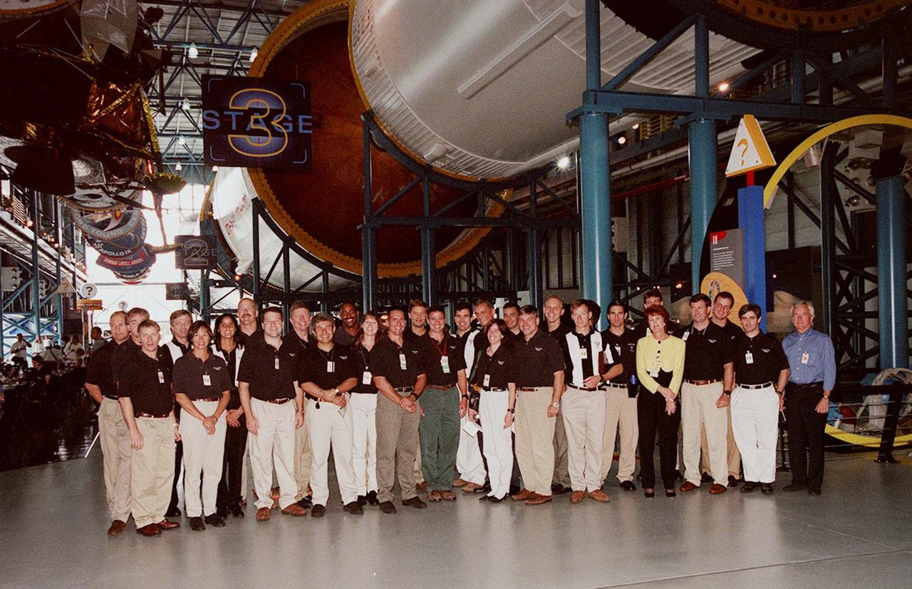 KENNEDY SPACE CENTER, FLA. -- At the Apollo/Saturn V Center, some of the 1998 astronaut candidate class (group 17) line up for a photo during a tour of facilities at KSC. The U.S. candidates include Clayton C. Anderson, Lee J. Archambault, Tracy E. Caldwell (Ph.D.), Gregory E. Chamitoff (Ph.D.), Timothy J. Creamer, Christopher J. Ferguson, Michael J. Foreman, Michael E. Fossum, Kenneth T. Ham, Patricia C. Hilliard (M.D.), Gregory C. Johnson, Gregory H. Johnson, Stanley G. Love (Ph.D.), Leland D. Melvin, Barbara R. Morgan, William A. Oefelein, John D. Olivas (Ph.D.), Nicholas J.M. Patrick (Ph.D.), Alan G. Poindexter, Garrett E. Reisman (Ph.D.), Steven R. Swanson, Douglas H. Wheelock, Sunita L. Williams, Neil W. Woodward III, George D. Zamka; and international candidates Leopold Eyharts, Paolo Nespoli, Hans Schlegel, Roberto Vittori, Bjarni V. Tryggvason, and Marcos Pontes. The class is at KSC for training activities, including fire training and a flight awareness program, plus touring the OPF, SSME Processing Facility, VAB, SSPF, launch pads, SLF and the crew headquarters