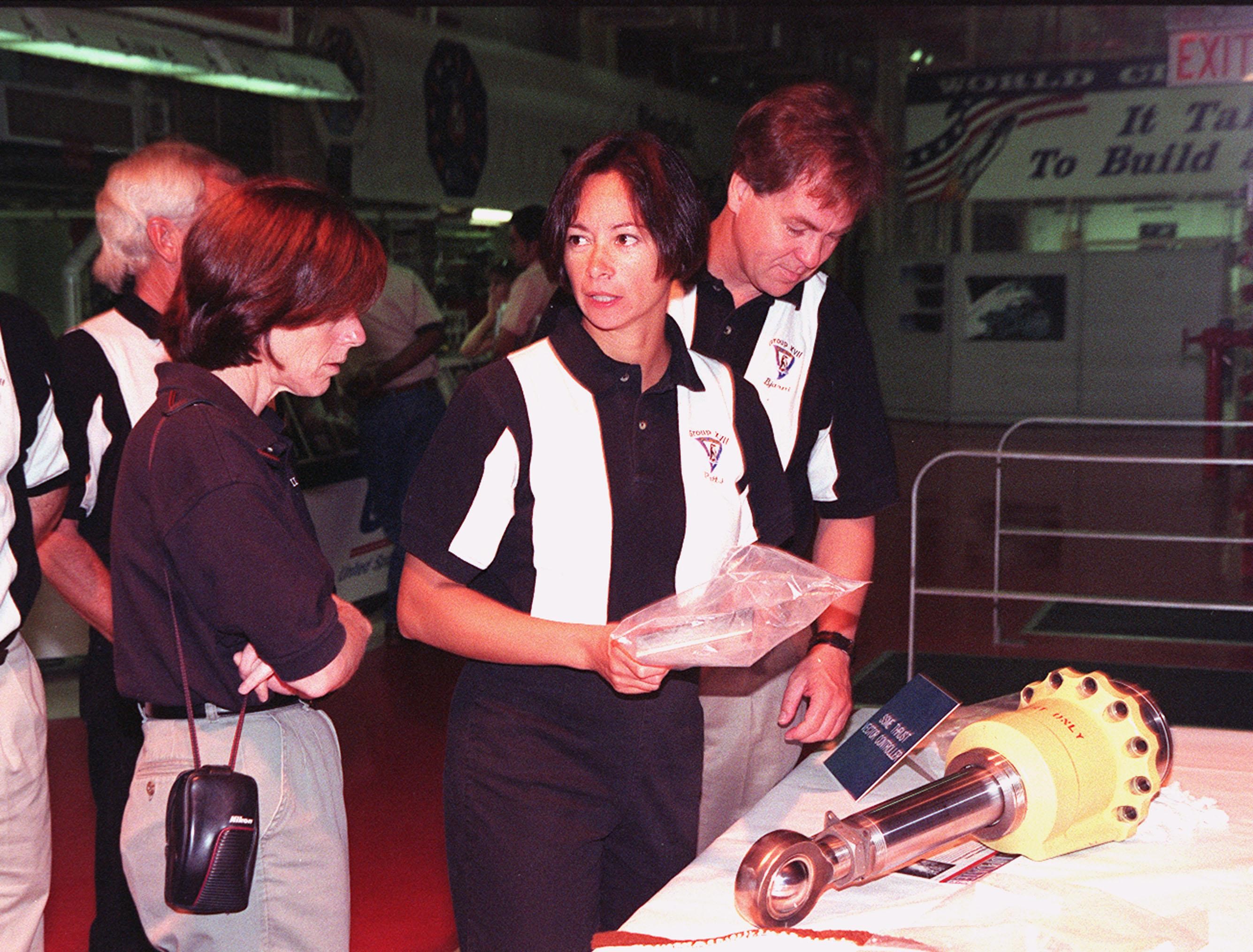 In the Orbiter Processing Facility, 1998 astronaut candidates (ASCAN) Barbara R. Morgan, Patricia C. Hilliard (M.D.) and Bjarni V. Tryggvason look at the hardware exhibits, such as the engine actuator on the table. Tryggvason is with the Canadian Space Agency. The 1998 ASCAN class is at KSC for training activities, including fire training and a flight awareness program, plus touring the OPF, SSME Processing Facility, VAB, SSPF, launch pads, SLF, Apollo/Saturn V Center and the crew headquarters. Other U.S. candidates in the '98 class are Clayton C. Anderson, Lee J. Archambault, Tracy E. Caldwell (Ph.D.), Gregory E. Chamitoff (Ph.D.), Timothy J. Creamer, Christopher J. Ferguson, Michael J. Foreman, Michael E. Fossum, Kenneth T. Ham, Gregory C. Johnson, Gregory H. Johnson, Stanley G. Love (Ph.D.), Leland D. Melvin, William A. Oefelein, John D. Olivas (Ph.D.), Nicholas J.M. Patrick (Ph.D.), Alan G. Poindexter, Garrett E. Reisman (Ph.D.), Steven R. Swanson, Douglas H. Wheelock, Sunita L. Williams, Neil W. Woodward III, George D. Zamka; and the other international candidates are Leopold Eyharts, Paolo Nespoli, Hans Schlegel, Roberto Vittori, and Marcos Pontes