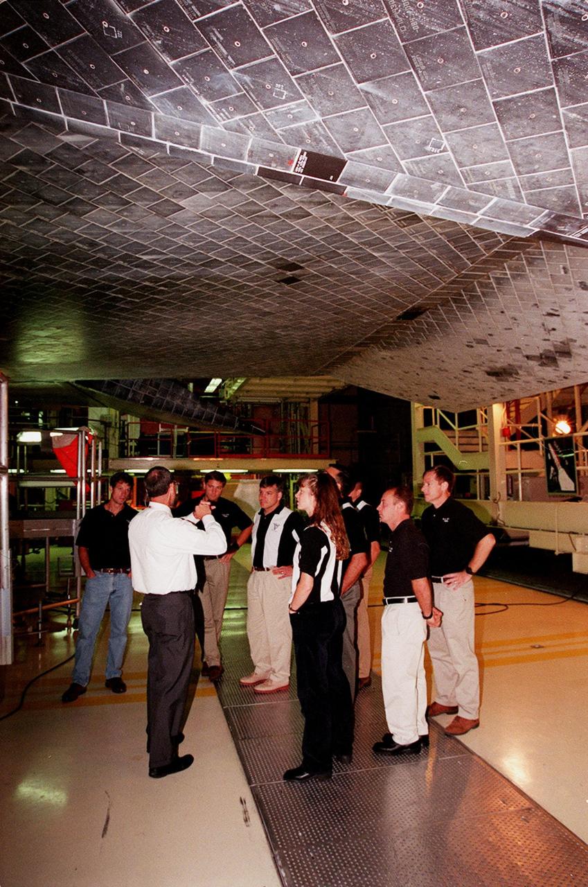 In the Orbiter Processing Facility, members of the 1998 astronaut candidate class (group 17) learn about the thermal protection system on the orbiters, such as Atlantis overhead. The class is at KSC for training activities, including fire training and a flight awareness program, plus touring the OPF, SSME Processing Facility, VAB, SSPF, launch pads, SLF, Apollo/Saturn V Center and the crew headquarters. The U.S. candidates in the '98 class are Clayton C. Anderson, Lee J. Archambault, Tracy E. Caldwell (Ph.D.), Gregory E. Chamitoff (Ph.D.), Timothy J. Creamer, Christopher J. Ferguson, Michael J. Foreman, Michael E. Fossum, Kenneth T. Ham, Patricia C. Hilliard (M.D.), Gregory C. Johnson, Gregory H. Johnson, Stanley G. Love (Ph.D.), Leland D. Melvin, Barbara R. Morgan, William A. Oefelein, John D. Olivas (Ph.D.), Nicholas J.M. Patrick (Ph.D.), Alan G. Poindexter, Garrett E. Reisman (Ph.D.), Steven R. Swanson, Douglas H. Wheelock, Sunita L. Williams, Neil W. Woodward III, George D. Zamka; and the international candidates are Leopold Eyharts, Paolo Nespoli, Hans Schlegel, Roberto Vittori, Bjarni V. Tryggvason, and Marcos Pontes