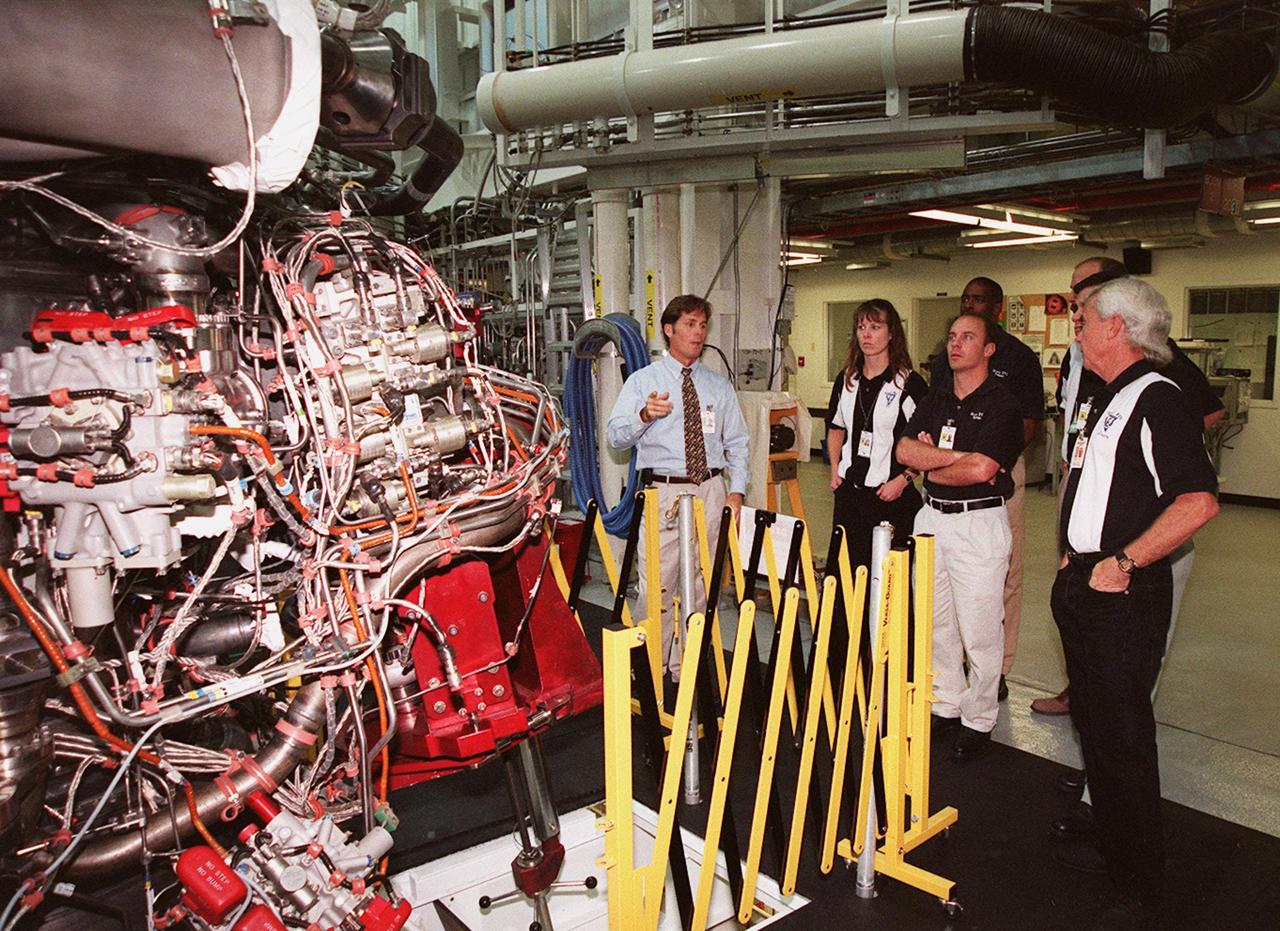 KENNEDY SPACE CENTER, FLA. -- On their tour of KSC, members of the 1998 astronaut candidate class (group 17) stop at the Space Shuttle Main Engine (SSME) Processing Facility for a close up look at a main shuttle engine. The class is taking part in training activities, including fire training and a flight awareness program, plus touring the OPF, VAB, SSPF, launch pads, SLF, Apollo/Saturn V Center, the crew headquarters, as well as the SSME Processing Facility. The U.S. candidates in the '98 class are Clayton C. Anderson, Lee J. Archambault, Tracy E. Caldwell (Ph.D.), Gregory E. Chamitoff (Ph.D.), Timothy J. Creamer, Christopher J. Ferguson, Michael J. Foreman, Michael E. Fossum, Kenneth T. Ham, Patricia C. Hilliard (M.D.), Gregory C. Johnson, Gregory H. Johnson, Stanley G. Love (Ph.D.), Leland D. Melvin, Barbara R. Morgan, William A. Oefelein, John D. Olivas (Ph.D.), Nicholas J.M. Patrick (Ph.D.), Alan G. Poindexter, Garrett E. Reisman (Ph.D.), Steven R. Swanson, Douglas H. Wheelock, Sunita L. Williams, Neil W. Woodward III, George D. Zamka; and the international candidates are Leopold Eyharts, Paolo Nespoli, Hans Schlegel, Roberto Vittori, Bjarni V. Tryggvason, and Marcos Pontes