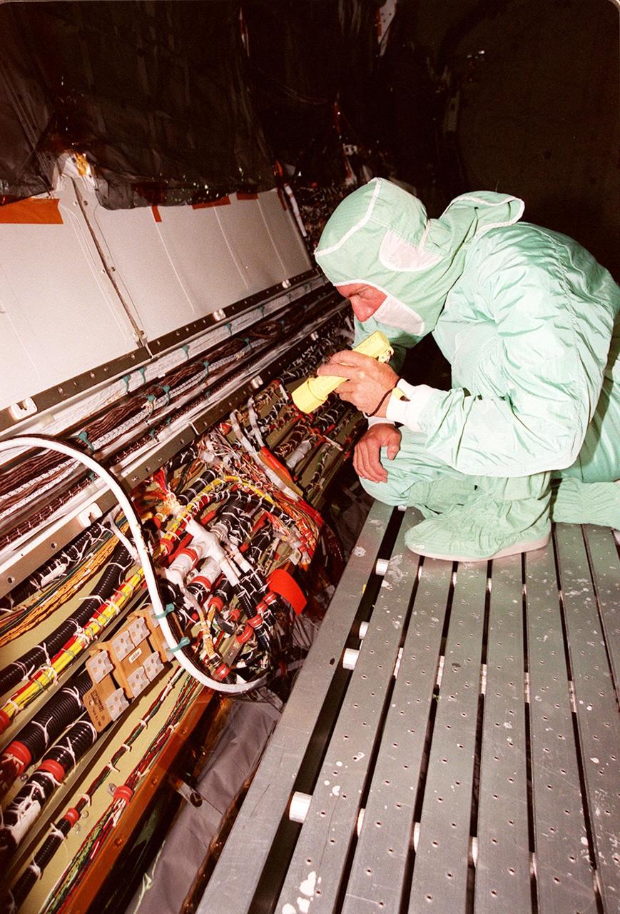 A short during liftoff of Space Shuttle Columbia in July was traced to a wire in the payload bay with damaged insulation. As a result of that problem, NASA decided to inspect much of the wiring in all four Space Shuttles and make repairs as required. Here a technician is examining the wires onboard orbiter Endeavour. The next Shuttle mission, STS-103, the Third Hubble Space Telescope Servicing Mission, is currently scheduled for launch no earlier than Nov. 19, 1999