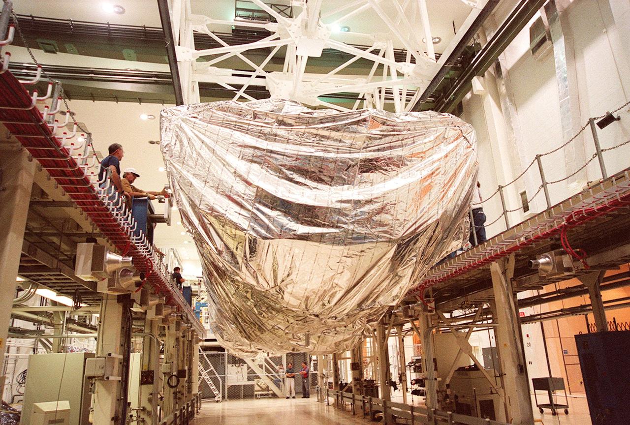 KENNEDY SPACE CENTER, FLA. -- Inside the Operations and Checkout Building, the S1 truss, a segment of the International Space Station, is lowered toward workstand number three. Manufactured by the Boeing Co. in Huntington Beach, Calif., this component of the International Space Station is the first starboard (right-side) truss segment, whose main job is providing structural support for the orbiting research facility's radiator panels that cool the Space Station's complex power system. The S1 truss segment also will house communications systems, external experiment positions and other subsystems. Primarily constructed of aluminum, the truss segment is 45 feet long, 15 feet wide and 6 feet tall. When fully outfitted, it will weigh 31,137 pounds. The truss is slated for flight in 2001