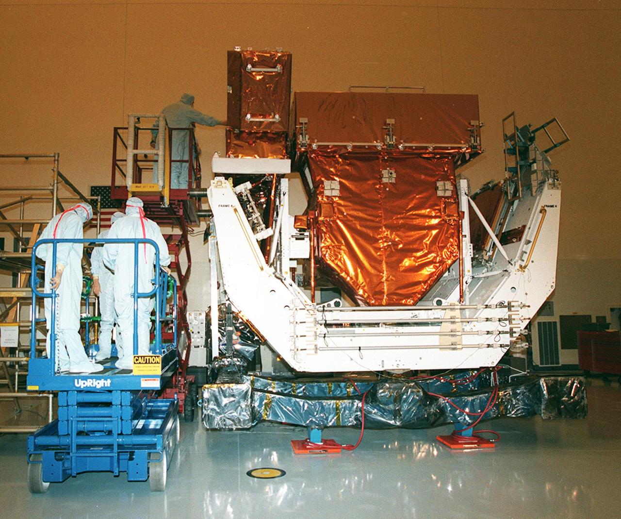 In the Payload Hazardous Servicing Facility clean room, the Orbital Replacement Unit Carrier, part of the flight hardware for the Hubble Space Telescope Servicing mission, is on display for media representatives. This mission is designed to replace aging parts on the nine-year-old observatory and to upgrade some of its functioning systems. During the flight, the astronaut crew will replace all six of Hubble's gyroscopes, a fine guidance sensor, the observatory's main computer, and other equipment. The 10-day mission is scheduled to launch no earlier than Dec. 2 at 4:32 a.m. EST from Launch Complex 39