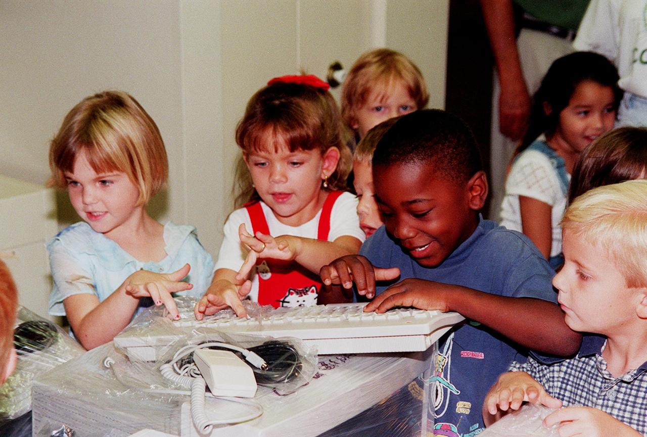 Children at Coquina Elementary School, Titusville, Fla., "practice" using a computer keyboard, part of equipment donated by Kennedy Space Center. Coquina is one of 13 Brevard County schools receiving 81 excess contractor computers thanks to an innovative educational outreach project spearheaded by the Nasa k-12 Education Services Office at ksc. The Astronaut Memorial Foundation, a strategic partner in the effort, and several schools in rural Florida and Georgia also received refurbished computers as part of the year-long project. KSC employees put in about 3,300 volunteer hours to transform old, excess computers into upgraded, usable units. A total of $90,000 in upgraded computer equipment is being donated