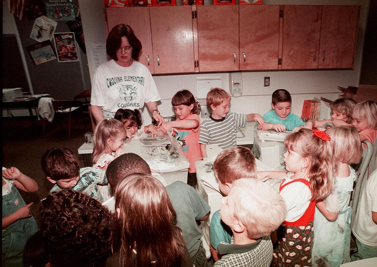 Children at Coquina Elementary School, Titusville, Fla., eagerly tear into the wrapped computer equipment donated by Kennedy Space Center. Coquina is one of 13 Brevard County schools receiving 81 excess contractor computers thanks to an innovative educational outreach project spearheaded by the Nasa k-12 Education Services Office at ksc. The Astronaut Memorial Foundation, a strategic partner in the effort, and several schools in rural Florida and Georgia also received refurbished computers as part of the year-long project. KSC employees put in about 3,300 volunteer hours to transform old, excess computers into upgraded, usable units. A total of $90,000 in upgraded computer equipment is being donated