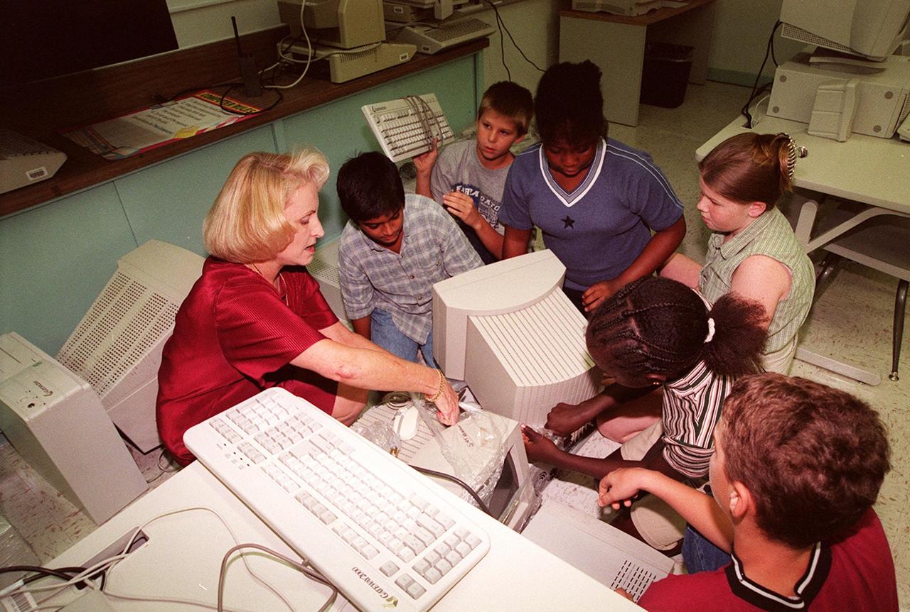 Nancy Nichols, principal of South Lake Elementary School, Titusville, Fla., joins students in teacher Michelle Butler's sixth grade class who are unwrapping computer equipment donated by Kennedy Space Center. South Lake is one of 13 Brevard County schools receiving 81 excess contractor computers thanks to an innovative educational outreach project spearheaded by the Nasa k-12 Education Services Office at ksc. The Astronaut Memorial Foundation, a strategic partner in the effort, and several schools in rural Florida and Georgia also received refurbished computers as part of the year-long project. KSC employees put in about 3,300 volunteer hours to transform old, excess computers into upgraded, usable units. A total of $90,000 in upgraded computer equipment is being donated