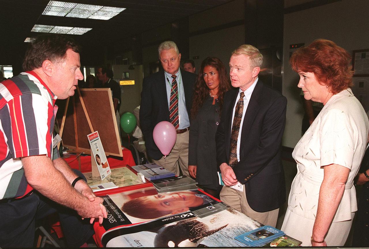 Center Director Roy Bridges stops to talk to one of the vendors at the Disability Awareness and Action Working Group (DAAWG) Technology Fair being held Oct. 20-21 at Kennedy Space Center. With him at the far left is Sterling Walker, director of Engineering Development at KSC and chairman of DAAWG, and Nancie Strott, a multi-media specialist with Dynacs and chairperson of the Fair; at the right is Carol Cavanaugh, with KSC Public Services. The Fair is highlighting vendors demonstrating mobility, hearing, vision and silent disability assistive technology. The purpose is to create an awareness of the types of technology currently available to assist people with various disabilities in the workplace. The theme is that of this year's National Disability Employment Awareness Month, "Opening Doors to Ability." Some of the vendors participating are Canine Companions for Independence, Goodwill Industries, Accessible Structures, Division of Blind Services, Space Coast Center for Independent Living, KSC Fitness Center and Delaware North Parks Services