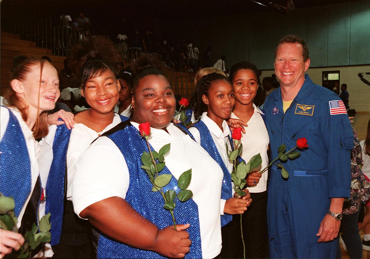 Dr. David Brown (right), a NASA astronaut, poses with students in the gymnasium of Ronald McNair Magnet School in Cocoa, Fla. From left, the students are Kristin Rexford, Danitra Anderson, Dominique Smith, Fallon Davis, and Qiana Taylor. Brown was at the school to attend a tribute to NASA astronaut Ronald McNair. The school had previously been renamed for the fallen astronaut who was one of a crew of seven, who lost their lives during an accident following launch of the Space Shuttle Challenger in January 1986