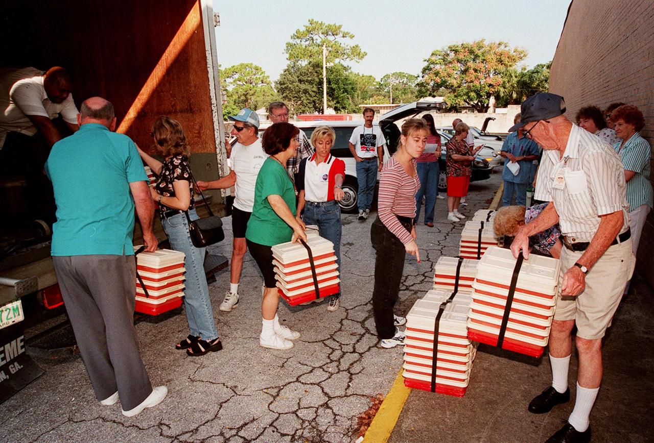 KSC volunteers at Miracle City Mall, Titusville, help unload containers for Meals on Wheels delivery as part of their '99 Days of Caring participation. The volunteers will also help deliver the meals. Coordinated by the KSC Community Relations Council, Days of Caring provides an opportunity for employees to volunteer their services in projects such as painting, planting flowers, reading to school children, and more. Organizations accepting volunteers include The Embers, Yellow Umbrella, Serene Harbor, Domestic Violence Program, the YMCA of Brevard County, and others