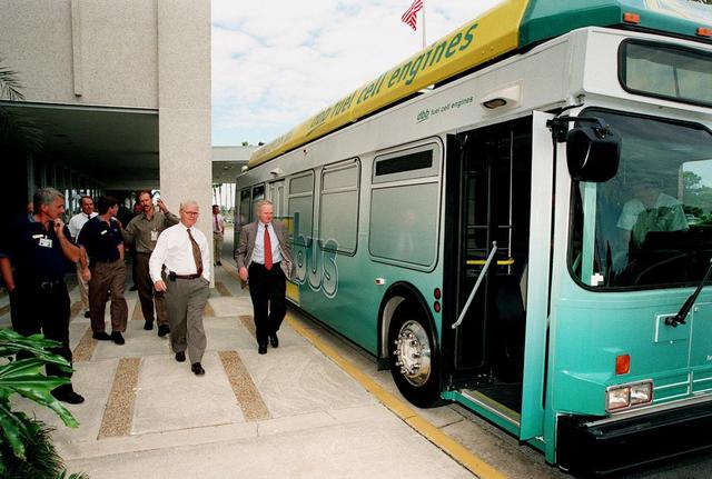 KSC workers, with Center Director Roy Bridges (at right next to bus), head for the open door of the Zero Emissions (ZE) transit bus and a ride around the center. Provided by dbb fuel cell engines inc. of Vancouver, Canada, the ZE bus was brought to KSC as part of the Center's Alternative Fuel Initiatives Program. The bus uses a Proton Exchange Membrane fuel cell in which hydrogen and oxygen, from atmospheric air, react to produce electricity that powers an electric motor drive system. The by-product "exhaust" from the fuel cell is water vapor, thus zero harmful emissions. A typical diesel-powered bus emits more than a ton of harmful pollutants from its exhaust every year. Available to employees for viewing and a ride, the ZE bus is also being used on tour routes at the KSC Visitor Complex Oct. 26-27