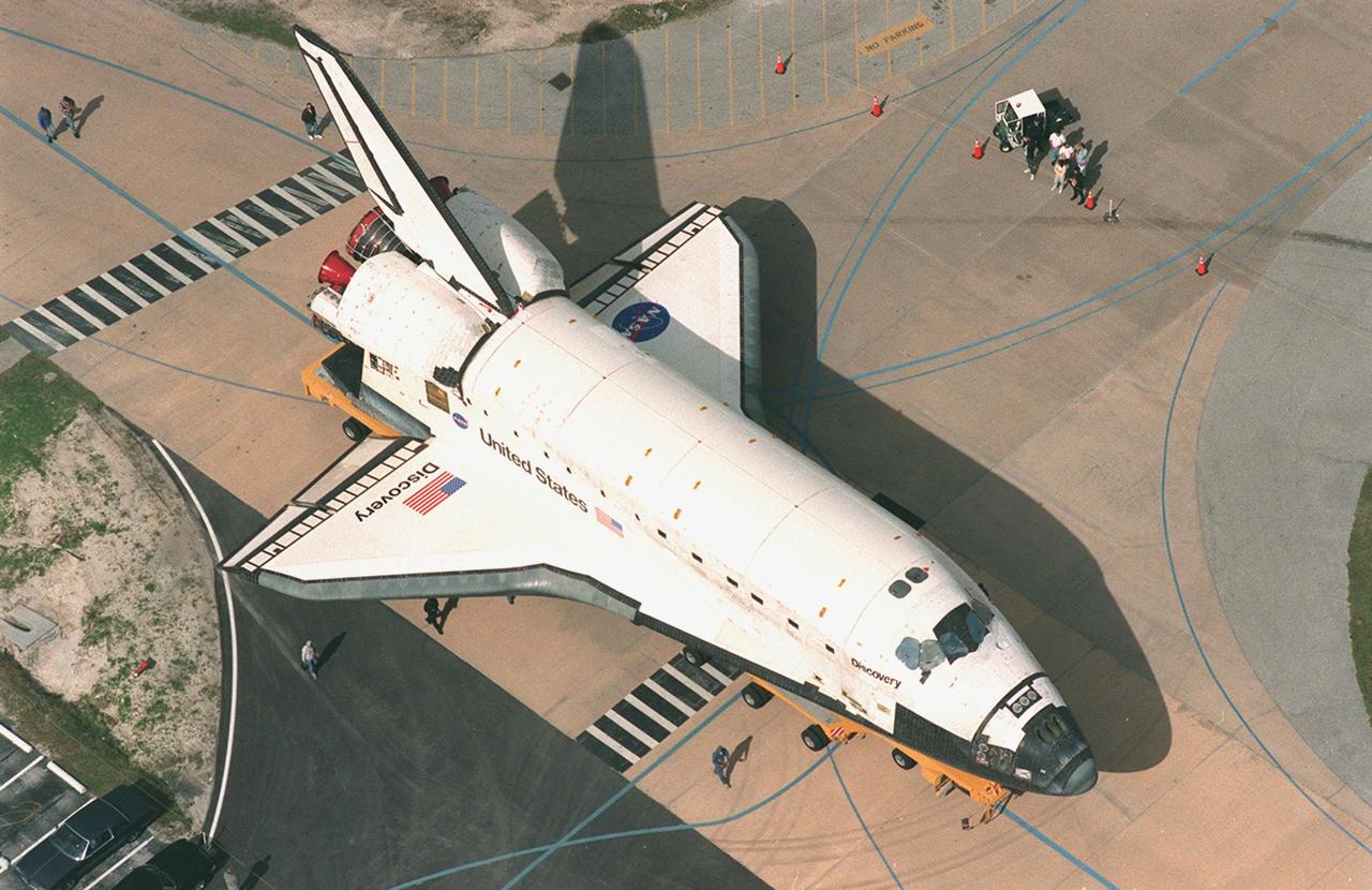 KENNEDY SPACE CENTER, FLA. -- The orbiter Discovery rolls along the tow-way to the Vehicle Assembly Building where it will be mated with an external tank and solid rocket boosters for its launch on mission STS-103. The launch date is currently under review for early December. STS-103, the third Hubble Space Telescope servicing mission, is a "call-up" due to the need to replace portions of the pointing system, the gyros, which have begun to fail on the Hubble Space Telescope. Although Hubble is operating normally and conducting its scientific observations, only three of its six gyroscopes are working properly. The gyroscopes allow the telescope to point at stars, galaxies and planets. The STS-103 crew will also be replacing a Fine Guidance Sensor and an older computer with a new enhanced model, an older data tape recorder with a solid-state digital recorder, a failed spare transmitter with a new one, and degraded insulation on the telescope with new thermal insulation. The crew will also install a Battery Voltage/Temperature Improvement Kit to protect the spacecraft batteries from overcharging and overheating when the telescope goes into a safe mode
