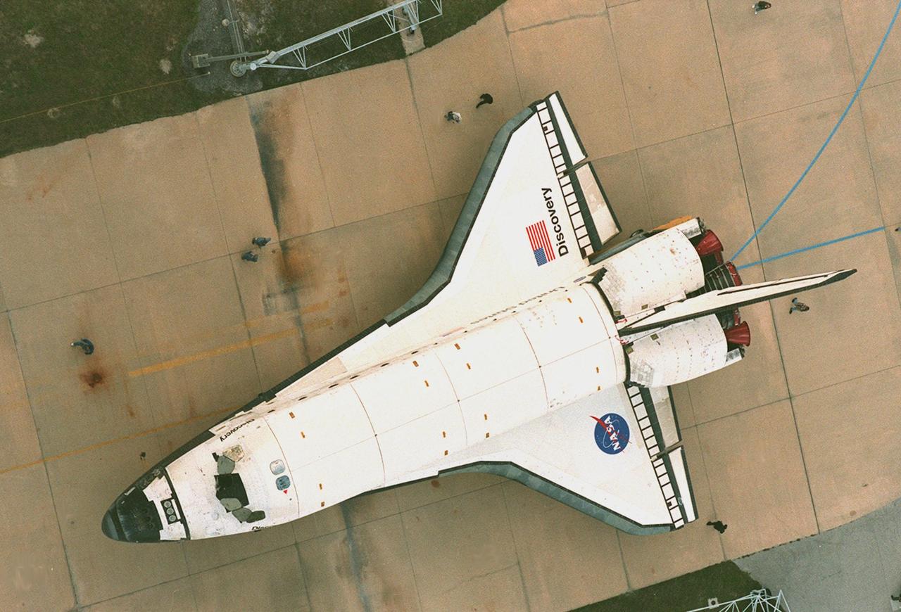 KENNEDY SPACE CENTER, FLA. -- The orbiter Discovery rolls along the tow-way to the Vehicle Assembly Building where it will be mated with an external tank and solid rocket boosters for its launch on mission STS-103. The launch date is currently under review for early December. STS-103, the third Hubble Space Telescope servicing mission, is a "call-up" due to the need to replace portions of the pointing system, the gyros, which have begun to fail on the Hubble Space Telescope. Although Hubble is operating normally and conducting its scientific observations, only three of its six gyroscopes are working properly. The gyroscopes allow the telescope to point at stars, galaxies and planets. The STS-103 crew will also be replacing a Fine Guidance Sensor and an older computer with a new enhanced model, an older data tape recorder with a solid-state digital recorder, a failed spare transmitter with a new one, and degraded insulation on the telescope with new thermal insulation. The crew will also install a Battery Voltage/Temperature Improvement Kit to protect the spacecraft batteries from overcharging and overheating when the telescope goes into a safe mode