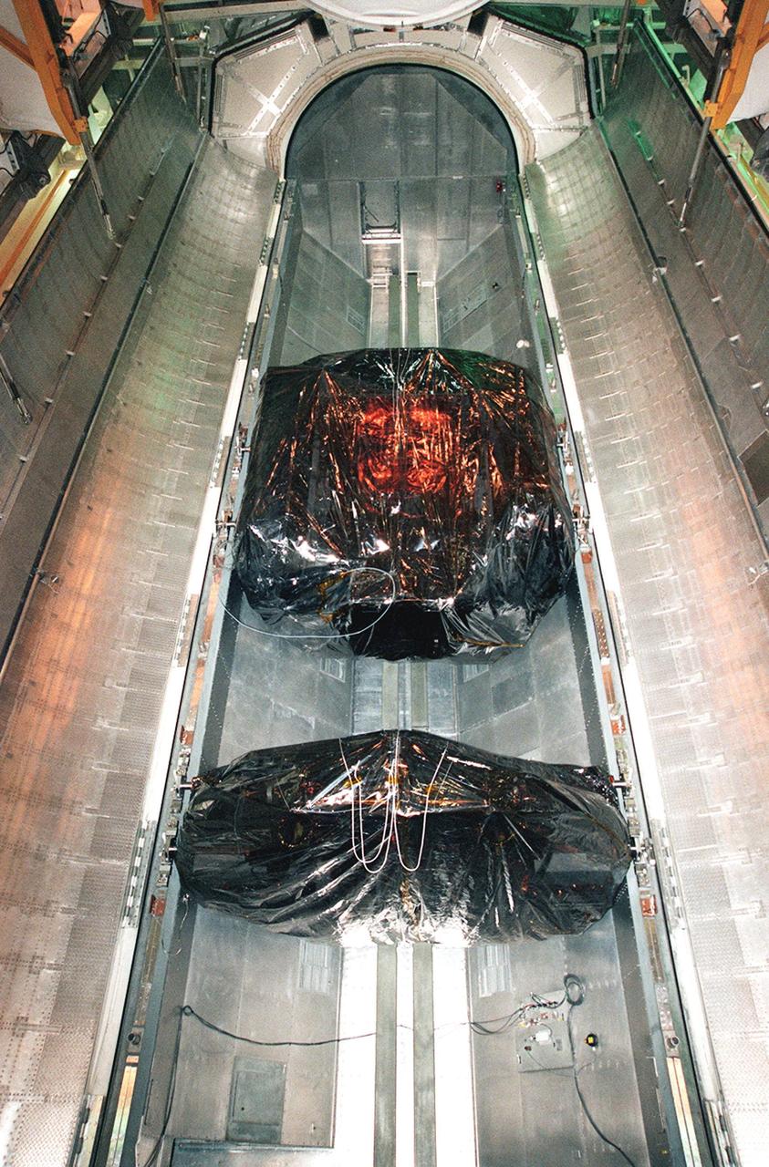 KENNEDY SPACE CENTER, FLA. -- At Launch Pad 39B, the open doors of the payload canister, inside the environmentally controlled Payload Changeout Room, reveal the Hubble Servicing Mission cargo. At the top is the Orbital Replacement Unit Carrier and at the bottom is the Flight Support System. Installation of the payload into Discovery is slated for Friday, Nov. 12. The mission is a "call-up" due to the need to replace portions of the pointing system, the gyros, which have begun to fail on the Hubble Space Telescope. Although Hubble is operating normally and conducting its scientific observations, only three of its six gyroscopes are working properly. The gyroscopes allow the telescope to point at stars, galaxies and planets. The STS-103 crew will also be replacing a Fine Guidance Sensor and an older computer with a new enhanced model, an older data tape recorder with a solid-state digital recorder, a failed spare transmitter with a new one, and degraded insulation on the telescope with new thermal insulation. The crew will also install a Battery Voltage/Temperature Improvement Kit to protect the spacecraft batteries from overcharging and overheating when the telescope goes into a safe mode