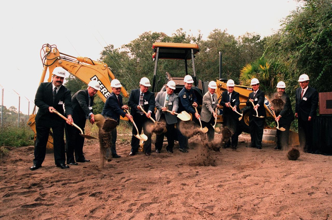 Dirt flies during a ground-breaking ceremony to kick off Astrotech Space Operations' construction of a new satellite preparation facility to support the Delta IV, Boeing's winning entrant in the Air Force Evolved Expendable Launch Vehicle (EELV) Program. Wielding shovels are (from left to right) Tom Alexico; Chet Lee, chairman, Astrotech Space Operations; Gen. Forrest McCartney, vice president, Launch Operations, Lockheed Martin; Richard Murphy, director, Delta Launch Operations, The Boeing Company; Keith Wendt; Toby Voltz; Loren Shriver, deputy director, Launch & Payload Processing, Kennedy Space Center; Truman Scarborough, Brevard County commissioner; U.S. Representative 15th Congressional District David Weldon; Ron Swank; and watching the action at right is George Baker, president, Astrotech Space Operations. Astrotech is located in Titusville, Fla. It is a wholly owned subsidiary of SPACEHAB, Inc., and has been awarded a 10-year contract to provide payload processing services for The Boeing Company. The facility will enable Astrotech to support the full range of satellite sizes planned for launch aboard Delta II, III and IV launch vehicles, as well as the Atlas V, Lockheed Martin's entrant in the EELV Program. The Atlas V will be used to launch satellites for government, including NASA, and commercial customers