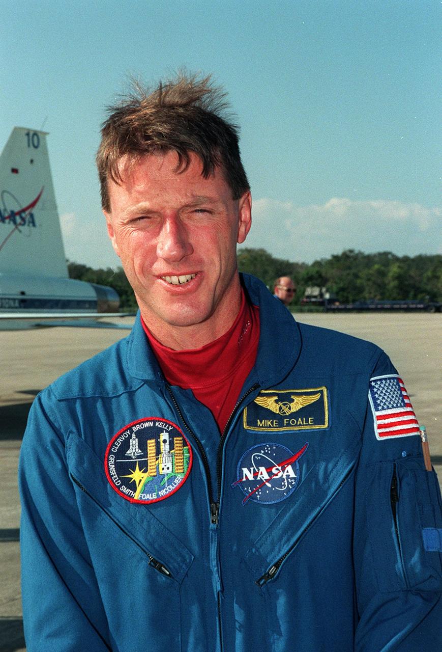 STS-103 Mission Specialist C. Michael Foale (Ph.D.) arrives at Kennedy Space Center's Shuttle Landing Facility to begin Terminal Countdown Demonstration Test (TCDT) activities. The TCDT provides the crew with emergency egress training, opportunities to inspect their mission payloads in the orbiter's payload bay, and simulated countdown exercises. Also participating are Commander Curtis L. Brown Jr., Pilot Scott J. Kelly, and Mission Specialists Steven L. Smith, John M. Grunsfeld (Ph.D.), Claude Nicollier of Switzerland, with the European Space Agency, and Jean-François Clervoy of France, also with the European Space Agency. The mission, to service the Hubble Space Telescope, is targeted for launch Dec. 6 at 2:37 a.m. EST aboard Space Shuttle Discovery