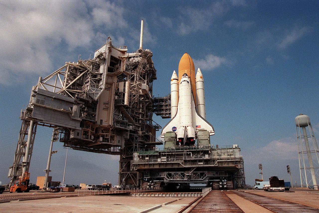 KENNEDY SPACE CENTER, Fla. -- Space Shuttle Discovery, atop the mobile launcher platform and crawler transporter, nears the top of Launch Pad 39B after the trekfrom the Vehicle Assembly Building. At left are the Rotating Service Structure and the Fixed Service Structure, which will enable final preparations of the orbiter, external tank and solid rocket boosters for the STS-103 launch targeted for Dec. 6, 1999, at 2:37 a.m. EST. The mission is a "call-up" due to the need to replace and repair portions of the Hubble Space Telescope. Although Hubble is operating normally and conducting its scientific observations, only three of its six gyroscopes are working properly. Four EVA's are planned to make the necessary repairs and replacements on the telescope. The STS-103 crew members are Commander Curtis L. Brown Jr., Pilot Scott J. Kelly, Steven L. Smith, C. Michael Foale (Ph.D.), John M. Grunsfeld (Ph.D.), and Claude Nicollier of Switzerland and Jean-François Clervoy of France, both with the European Space Agency
