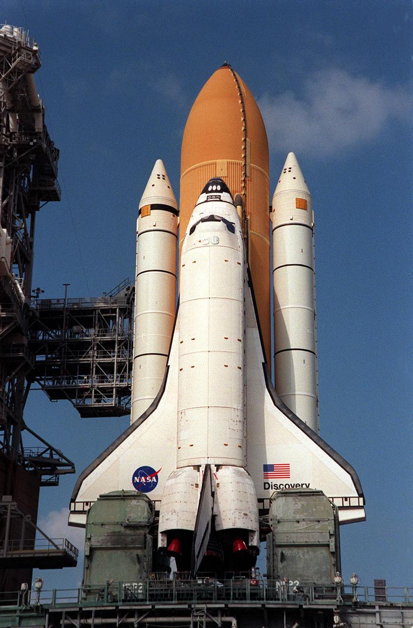 KENNEDY SPACE CENTER, Fla. -- Space Shuttle Discovery arrives at Launch Pad 39B where the orbiter, external tank and solid rocket boosters will undergo final preparations for the STS-103 launch. The mission is a "call-up" due to the need to replace and repair portions of the Hubble Space Telescope. Although Hubble is operating normally and conducting its scientific observations, only three of its six gyroscopes are working properly. Four EVA's are planned to make the necessary repairs and replacements on the telescope. The STS-103 crew members are Commander Curtis L. Brown Jr., Pilot Scott J. Kelly, Steven L. Smith, C. Michael Foale (Ph.D.), John M. Grunsfeld (Ph.D.), and Claude Nicollier of Switzerland and Jean-François Clervoy of France, both with the European Space Agency. The mission is targeted for launch Dec. 6 at 2:37 a.m. EST aboard Space Shuttle Discovery.