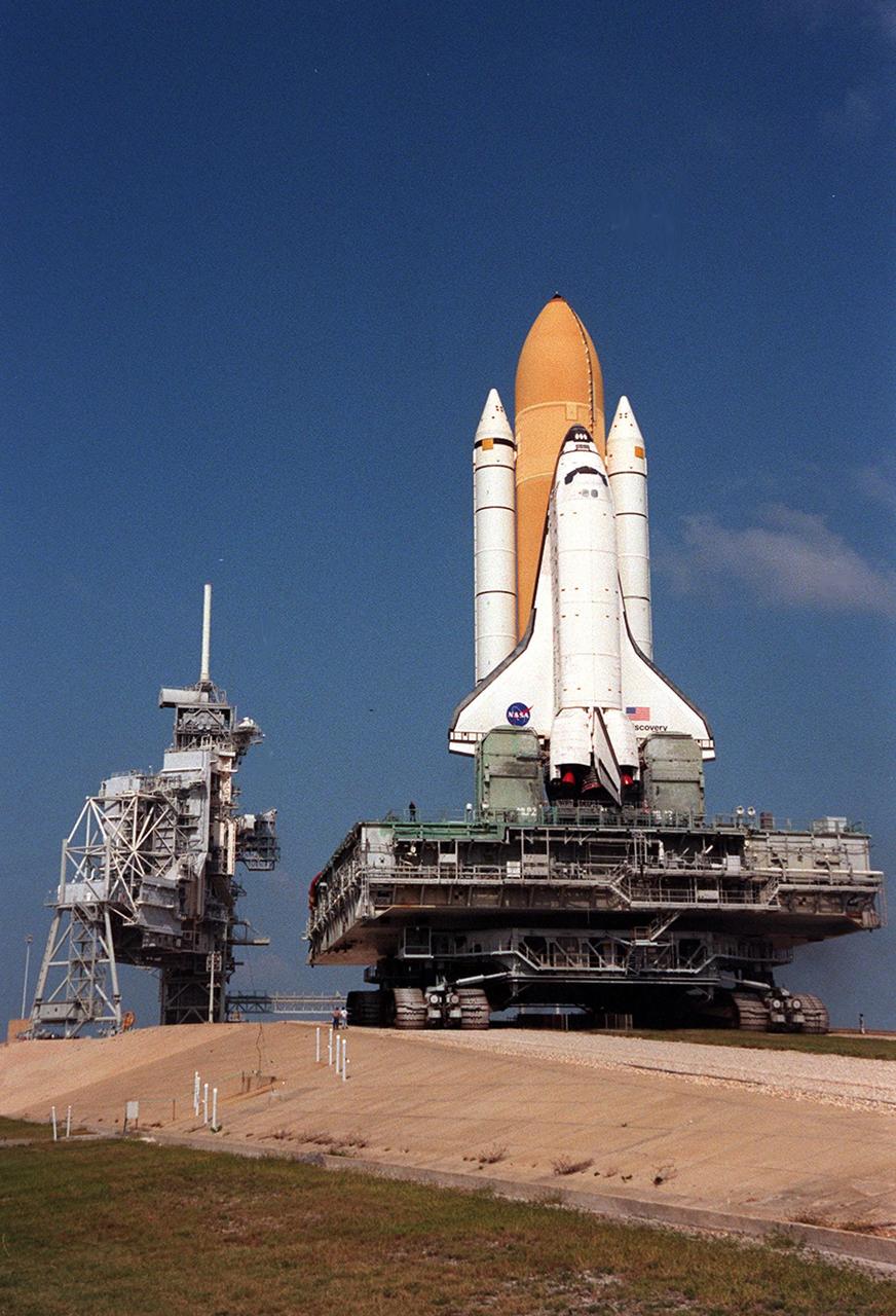 KENNEDY SPACE CENTER, Fla. -- Space Shuttle Discovery approaches Launch Pad 39B where the orbiter, external tank and solid rocket boosters will undergo final preparations for the STS-103 launch. The mission is a "call-up" due to the need to replace and repair portions of the Hubble Space Telescope. Although Hubble is operating normally and conducting its scientific observations, only three of its six gyroscopes are working properly. Four EVA's are planned to make the necessary repairs and replacements on the telescope. The STS-103 crew members are Commander Curtis L. Brown Jr., Pilot Scott J. Kelly, Steven L. Smith, C. Michael Foale (Ph.D.), John M. Grunsfeld (Ph.D.), and Claude Nicollier of Switzerland and Jean-François Clervoy of France, both with the European Space Agency. The mission is targeted for launch Dec. 6 at 2:37 a.m. EST.