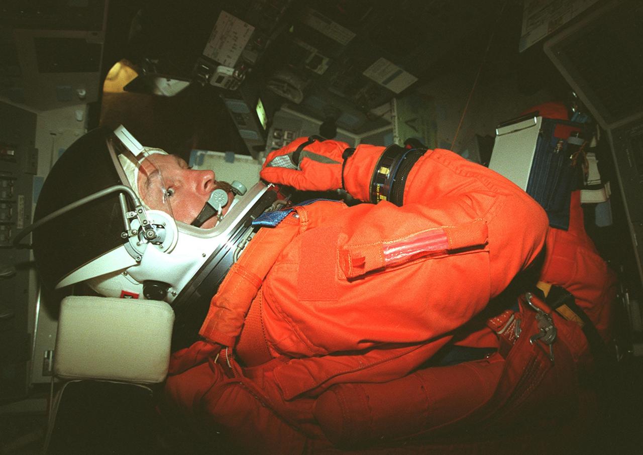 STS-103 Mission Commander Curtis L. Brown Jr. sits inside orbiter Discovery waiting for the start of a simulated countdown exercise. The simulation is part of Terminal Countdown Demonstration Test (TCDT) activities. The TCDT also provides the crew with emergency egress training and opportunities to inspect their mission payload in the orbiter's payload bay. Other crew members taking part in the TCDT are Pilot Scott J. Kelly, and Mission Specialists Steven L. Smith, C. Michael Foale (Ph.D.), John M. Grunsfeld (Ph.D.), Jean-François Clervoy of France, and Claude Nicollier of Switzerland. Clervoy and Nicollier are with the European Space Agency. STS-103 is a "call-up" mission due to the need to replace and repair portions of the Hubble Space Telescope, including the gyroscopes that allow the telescope to point at stars, galaxies and planets. The STS-103 crew will be replacing a Fine Guidance Sensor, an older computer with a new enhanced model, an older data tape recorder with a solid-state digital recorder, a failed spare transmitter with a new one, and degraded insulation on the telescope with new thermal insulation. The crew will also install a Battery Voltage/Temperature Improvement Kit to protect the spacecraft batteries from overcharging and overheating when the telescope goes into a safe mode. Four EVA's are planned to make the necessary repairs and replacements on the telescope. The mission is targeted for launch Dec. 6 at 2:37 a.m. EST