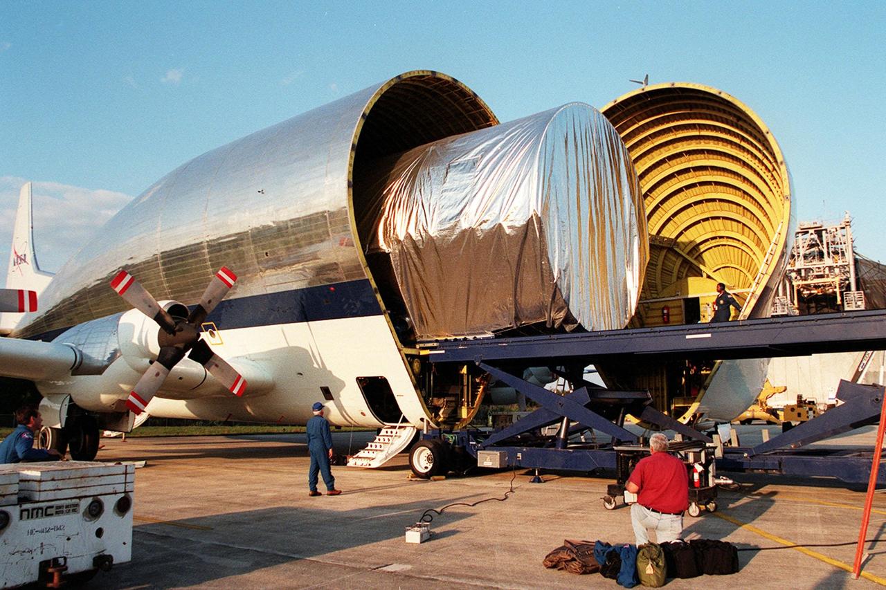 KENNEDY SPACE CENTER, FLA. -- At Kennedy Space Center's Shuttle Landing Facility, the cargo of NASA's Super Guppy aircraft begins rolling out onto a payload transporter. The cargo is a P3 port-side truss, a segment of the International Space Station (ISS). The truss is scheduled to be added to the ISS on mission STS-115 in 2002 aboard Space Shuttle Atlantis. The second port truss segment, P3 will be attached to the first port truss segment (P1). The P3 truss will be taken to the Operations and Checkout Building.